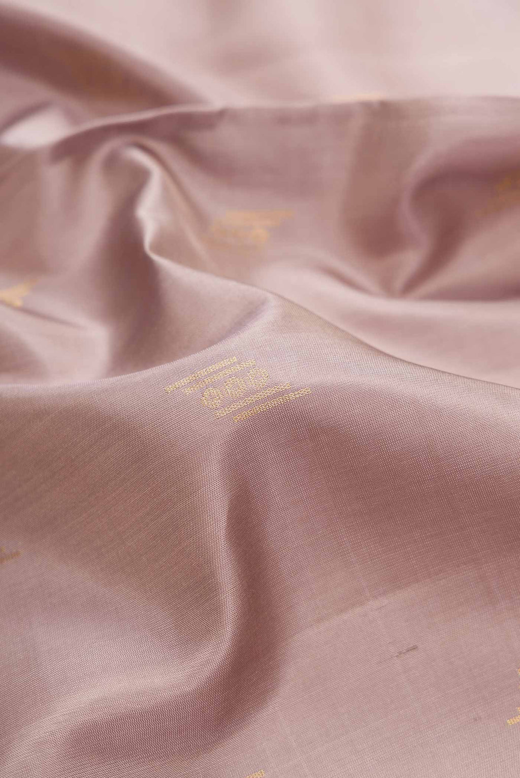Close up of Grey Dual Tone Soft Silk Saree with Zari Butta on the body and Zari Border.  displaying folds