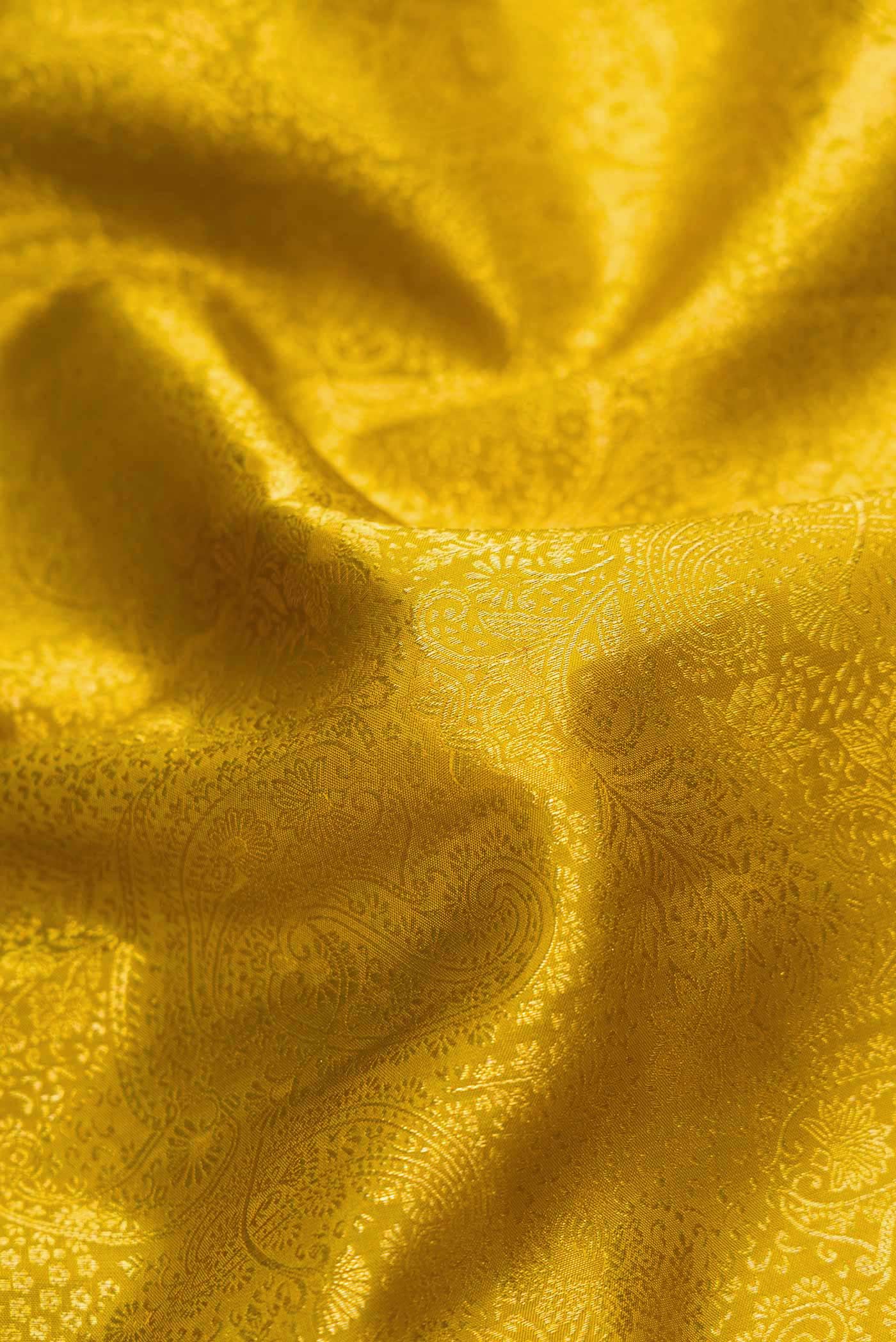 Close up of Mehandi Green Dual Tone Kanchipuram Silk Saree with Zari Brocade on the body and Zari Border.  displaying folds