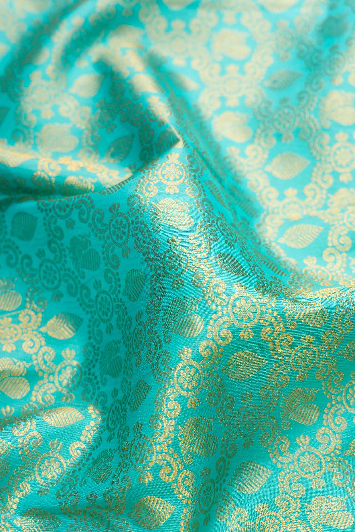 Close up of Sky Blue Dual Tone Kanchipuram Silk Saree with Zari Brocade on the body and Zari Border.  displaying folds
