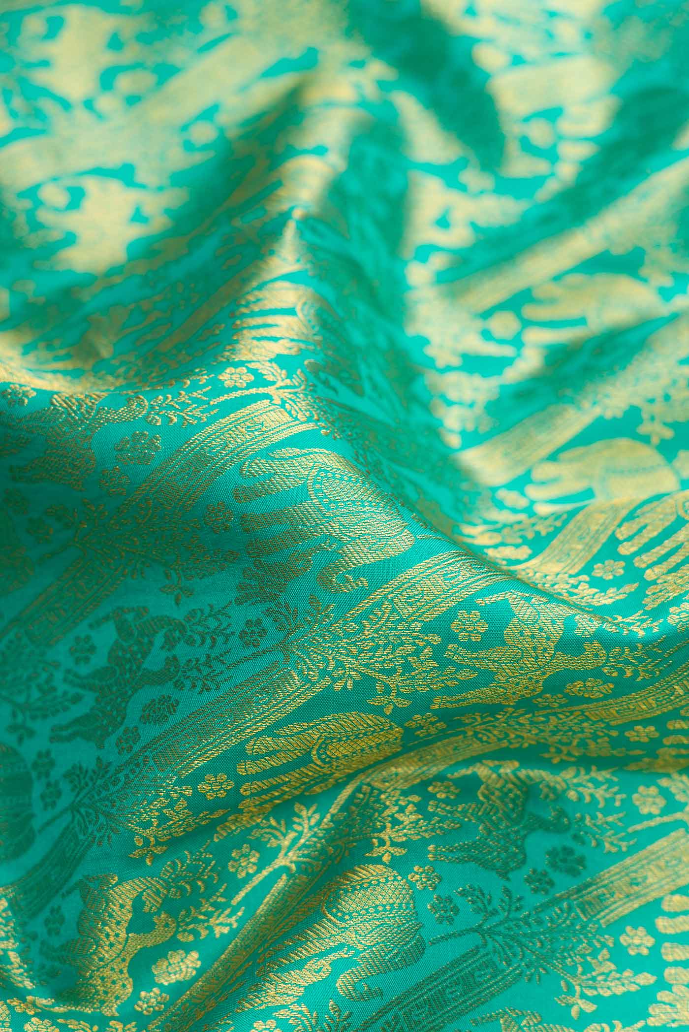 Close up of Sea Green Dual Tone Kanchipuram Silk Saree with Zari Brocade on the body and Zari Border.  displaying folds