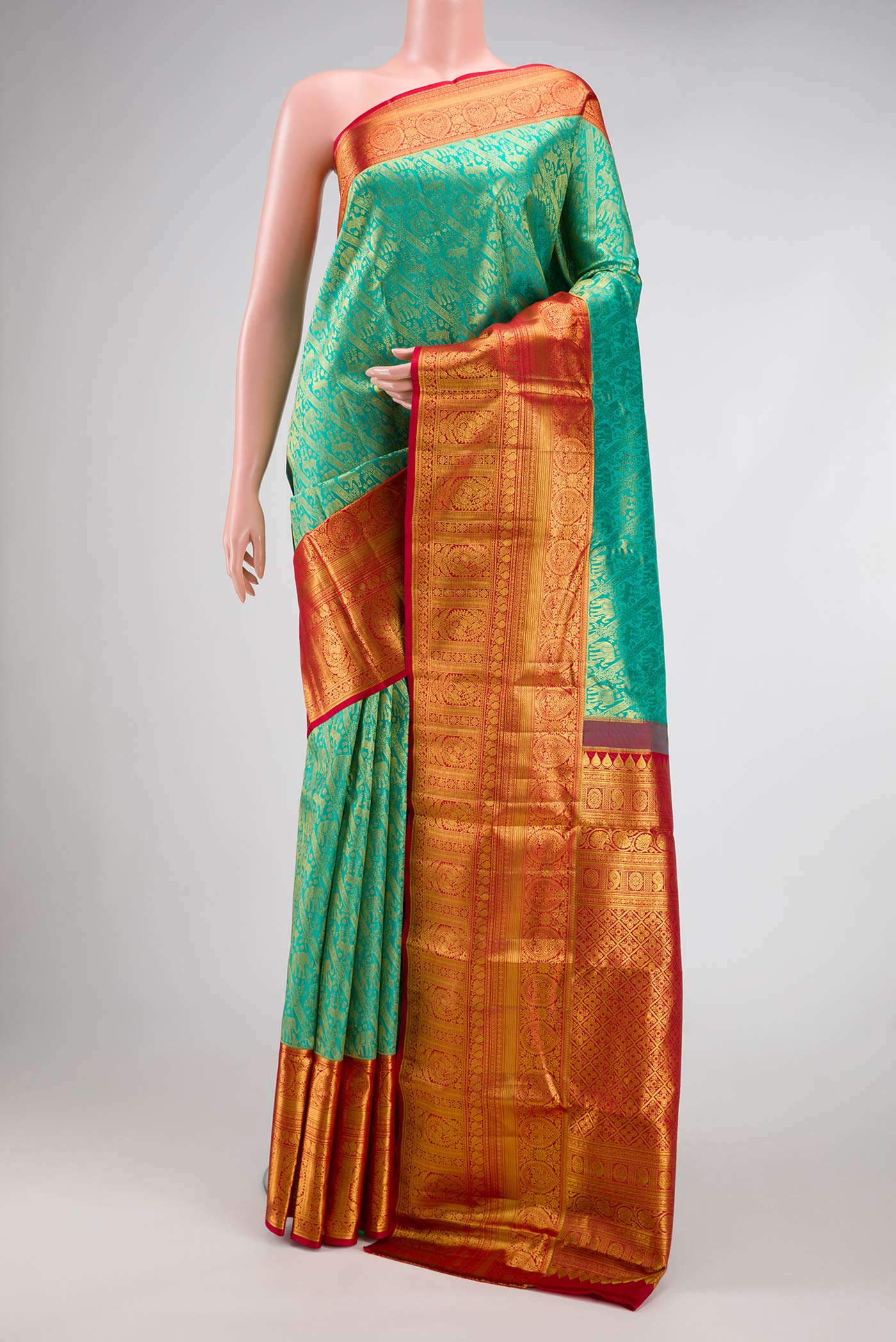 Sea Green Dual Tone Kanchipuram Silk Saree with Zari Brocade on the body and Zari Border.  displayed on a mannequin