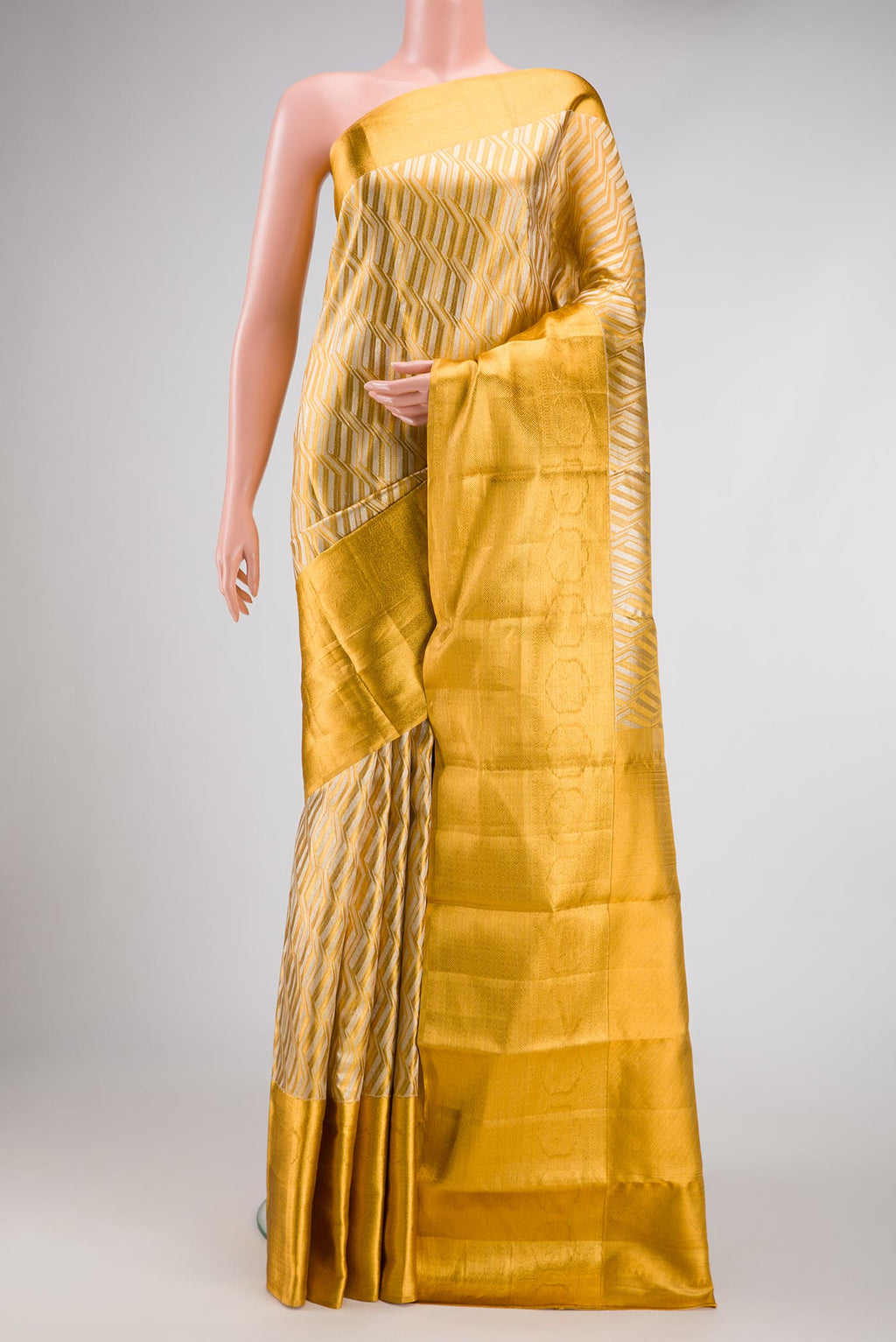 Gold Dual Tone Kanjivaram Tissue Silk Saree with Zari Brocade on the body and Zari Border.  displayed on a mannequin