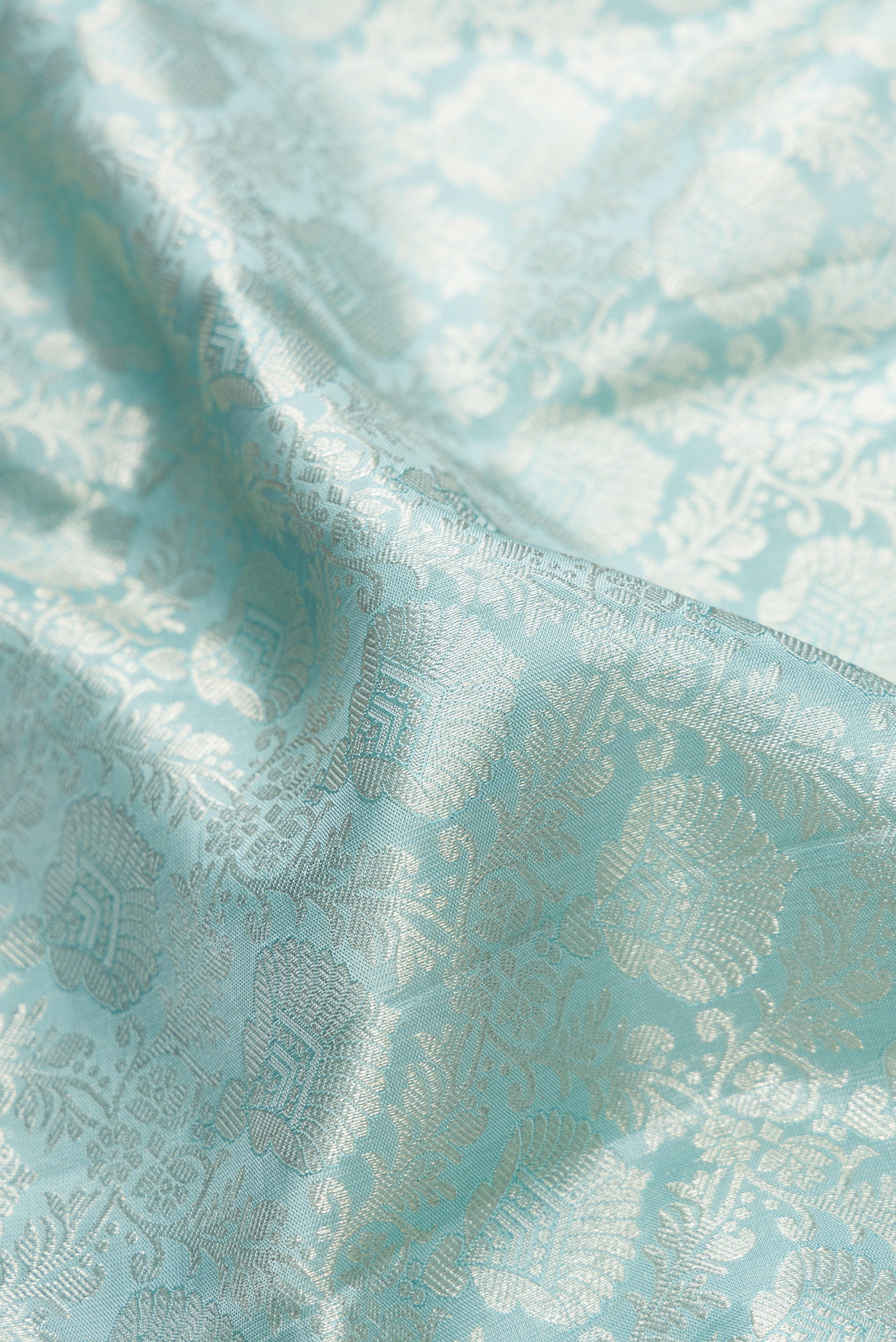 Close up of Maya Blue Dual Tone Kanjivaram Silk Saree with Zari Brocade on the body and Fancy Border.  displaying folds