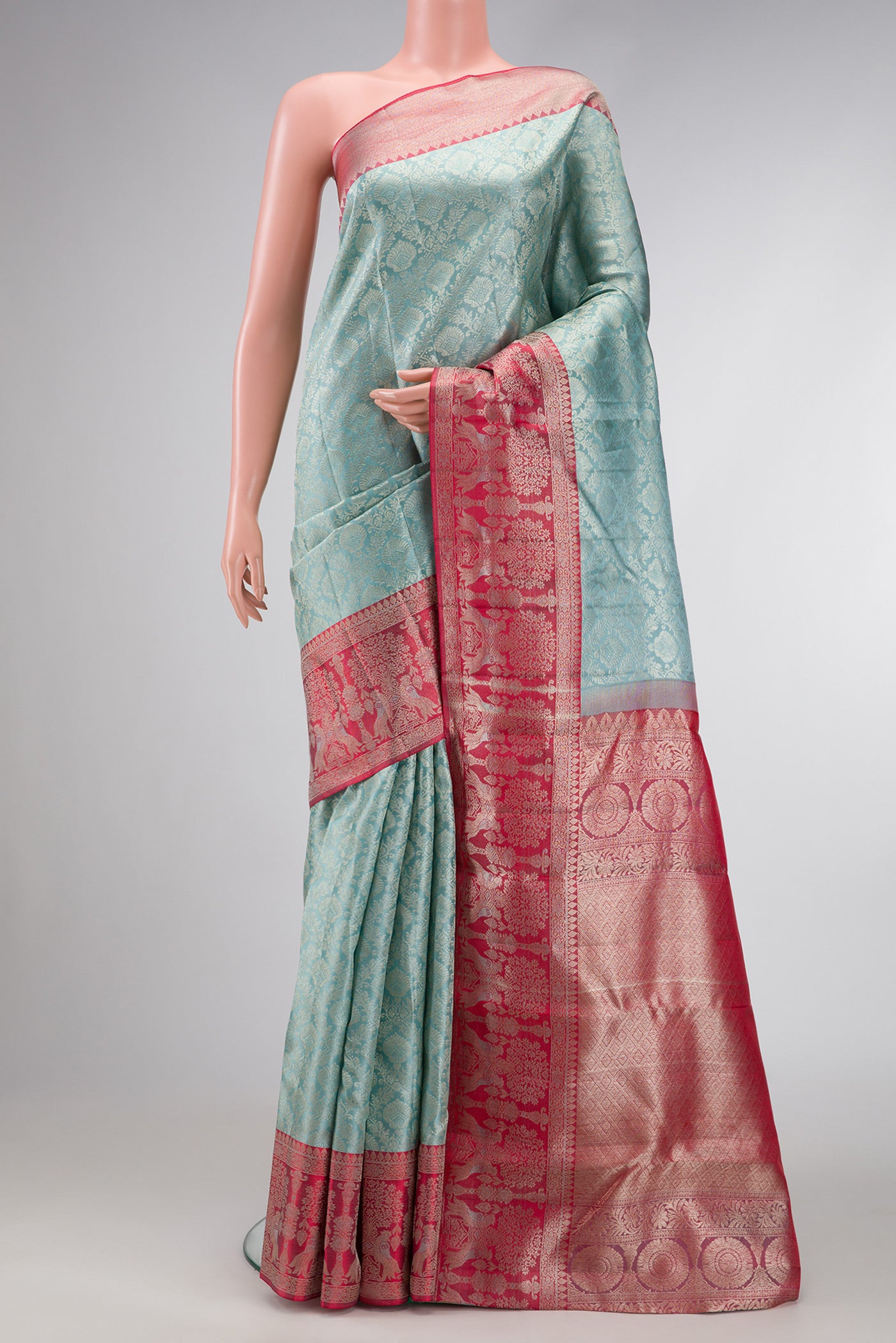Maya Blue Dual Tone Kanjivaram Silk Saree with Zari Brocade on the body and Fancy Border.  displayed on a mannequin