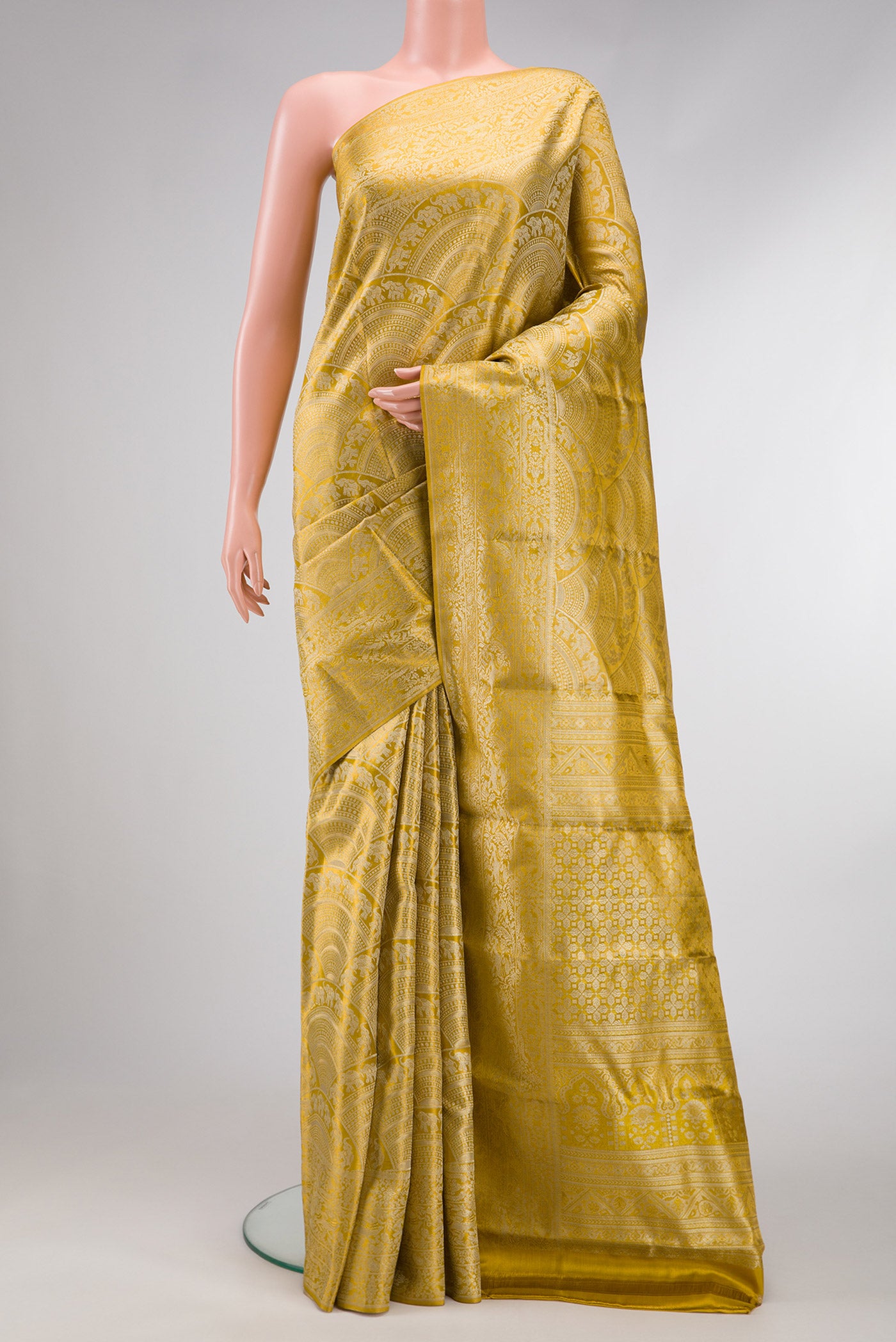 Gold Dual Tone Kanchipuram Tissue Silk Saree with Zari Brocade on the body and Zari Border.  displayed on a mannequin