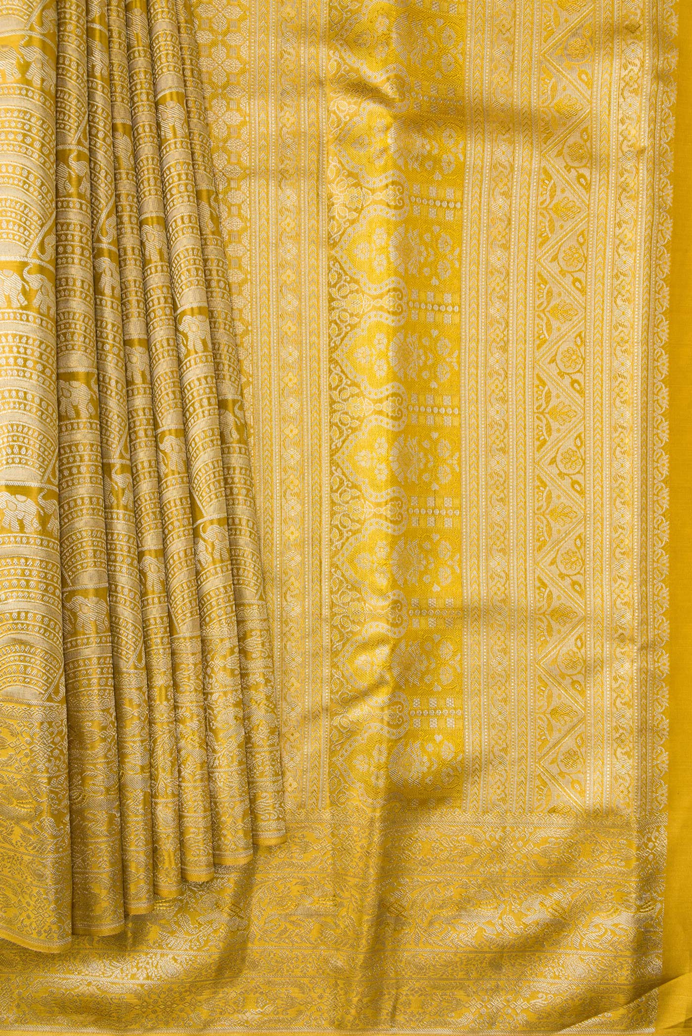 Pleats and pallu of Gold Dual Tone Kanchipuram Tissue Silk Saree with Zari Brocade on the body and Zari Border. 