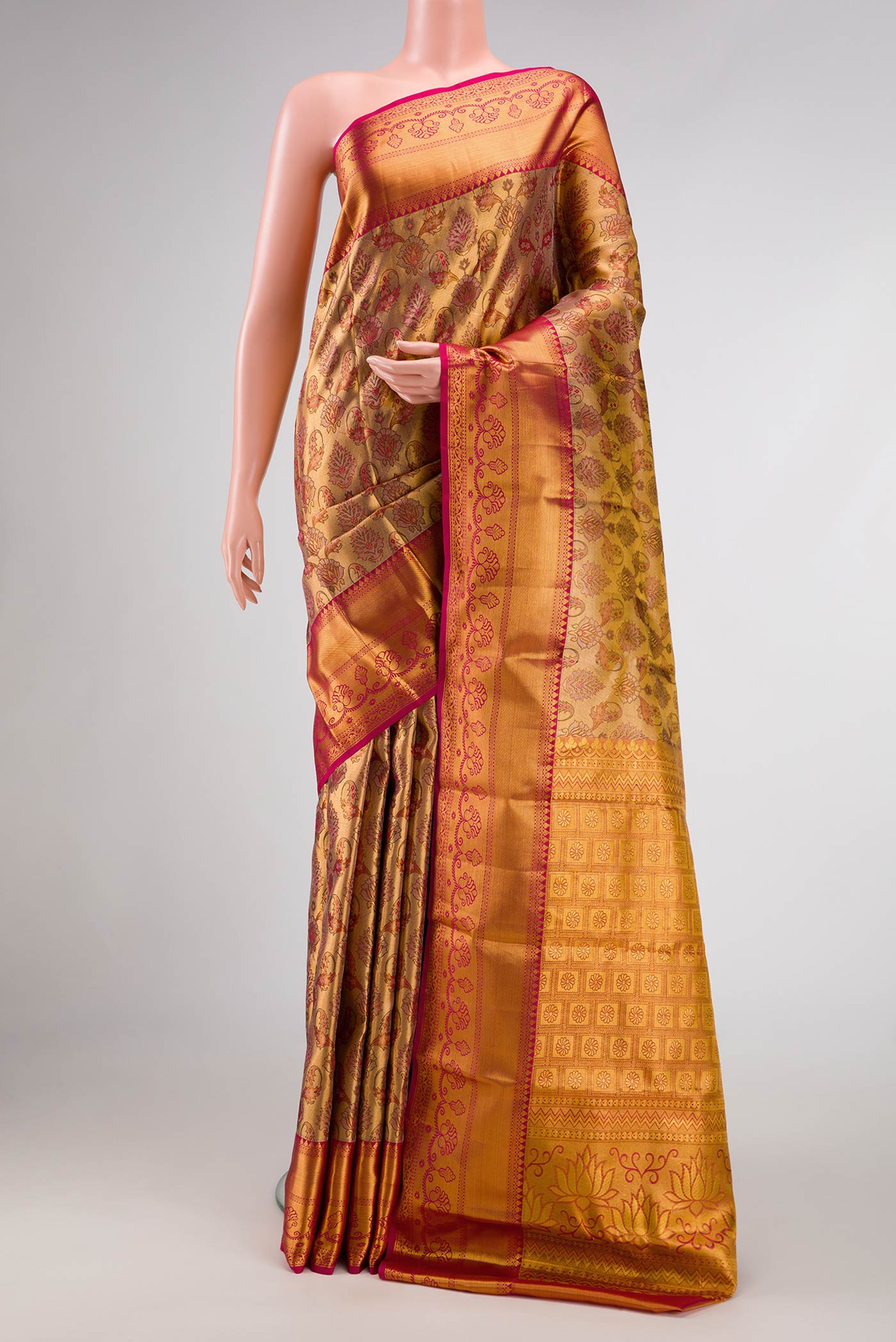 Gold Dual Tone Kanjivaram Tissue Silk Saree with Zari Brocade on the body and Zari Border.  displayed on a mannequin