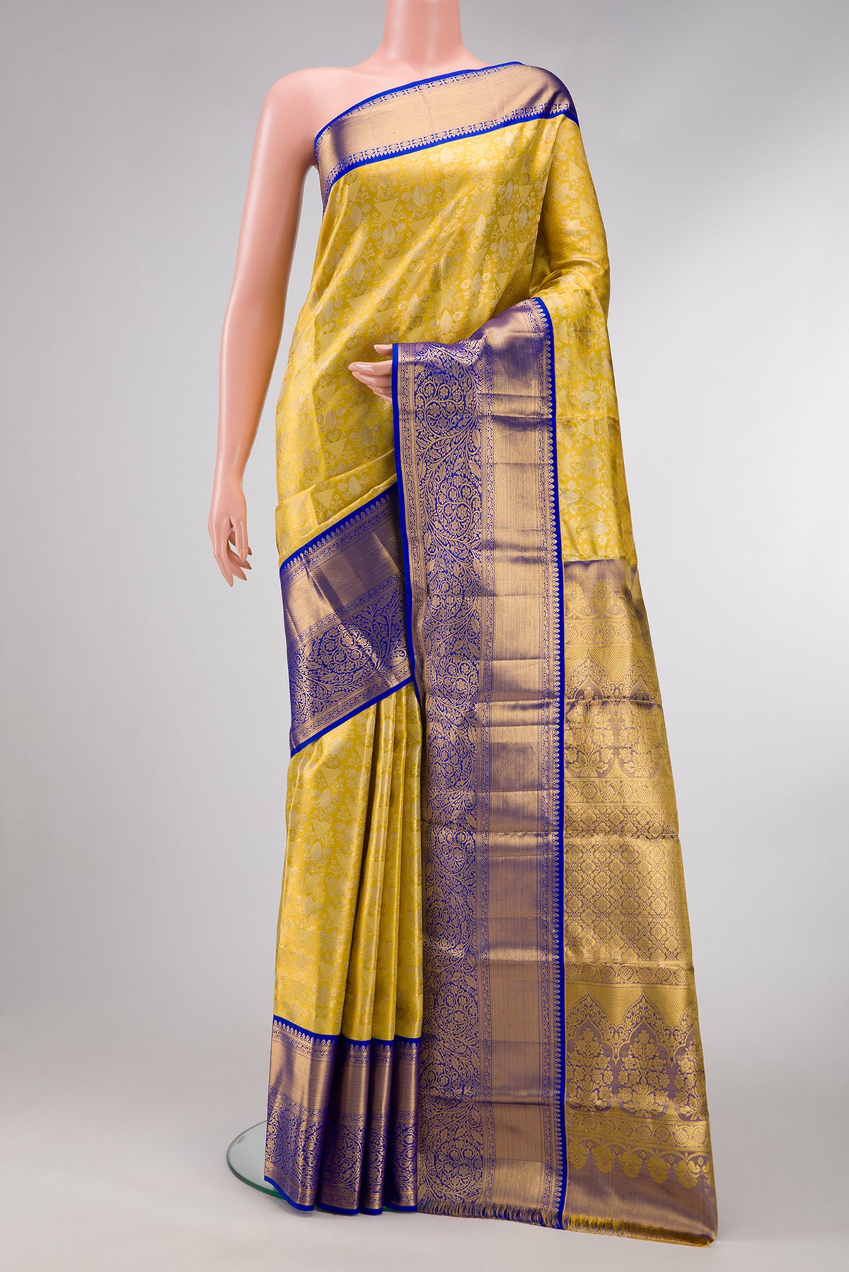 Gold Dual Tone Kanjivaram Tissue Silk Saree with Zari Brocade on the body and Zari Border.  displayed on a mannequin