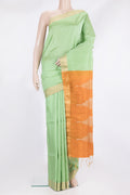 Pure Silk Pista Green Raw Saree with Plain Body and Zari Border.  displayed on a mannequin