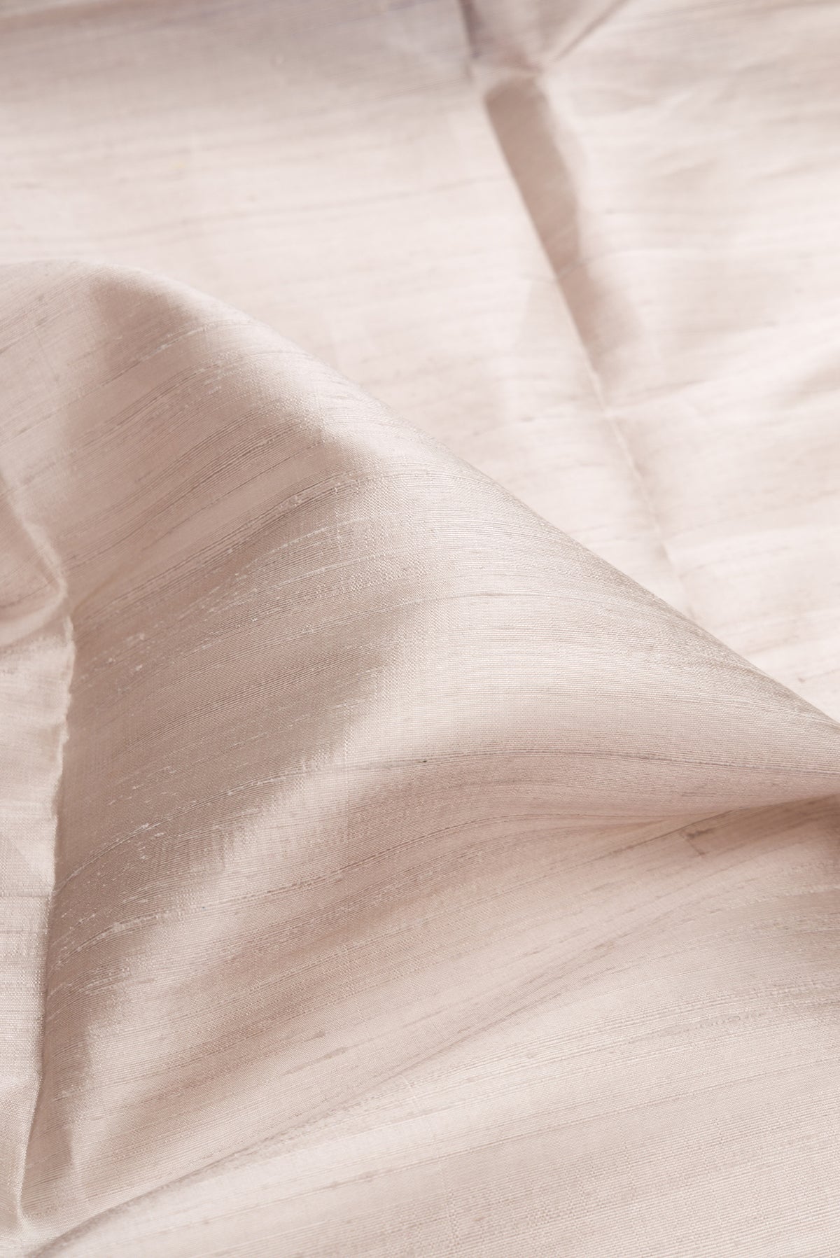 Close up of Grey Dual Tone Raw Silk Saree with Plain Body and Zari Border.  displaying folds
