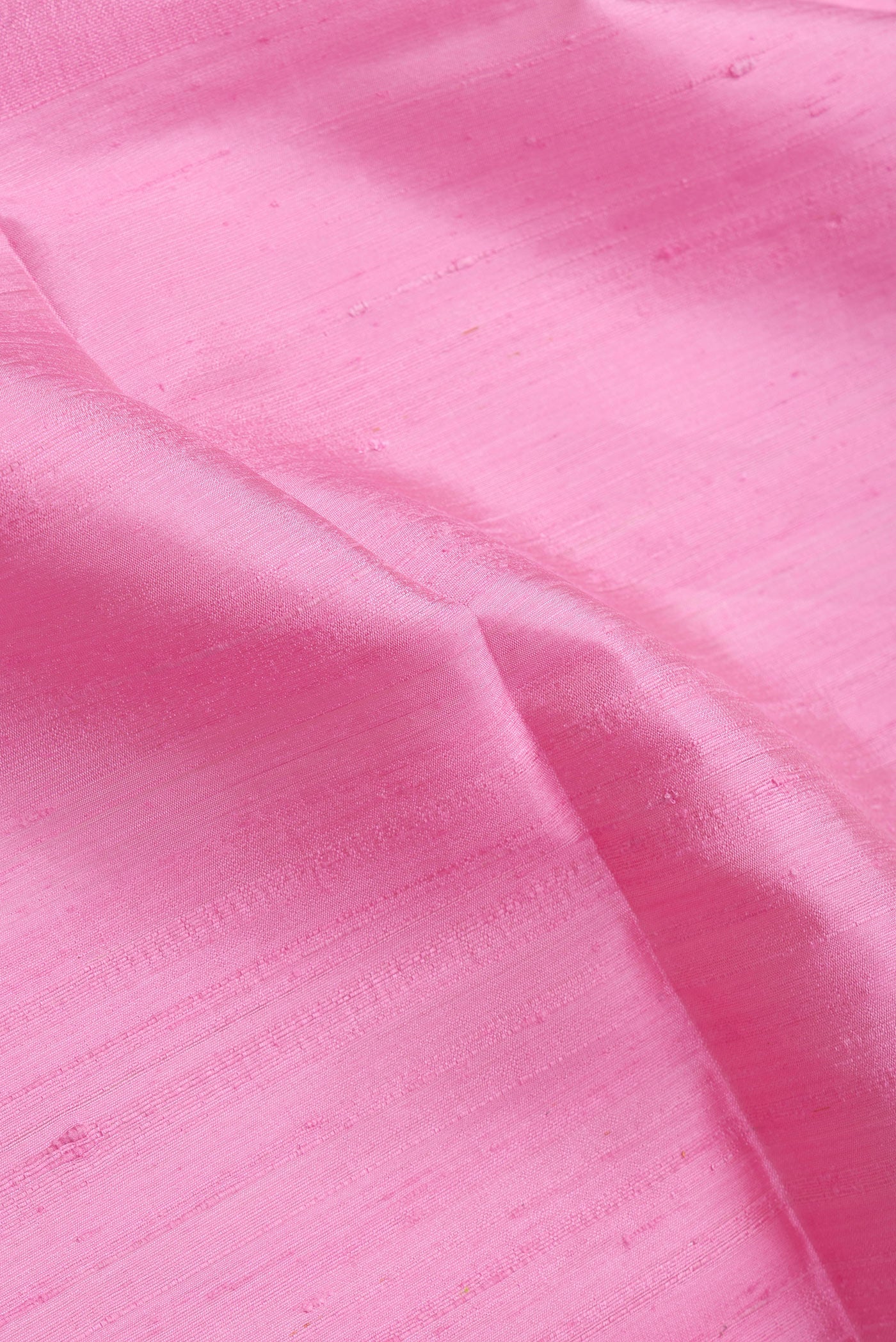 Close up of Pink Dual Tone Raw Silk Saree with Plain Body and Fancy Border.  displaying folds