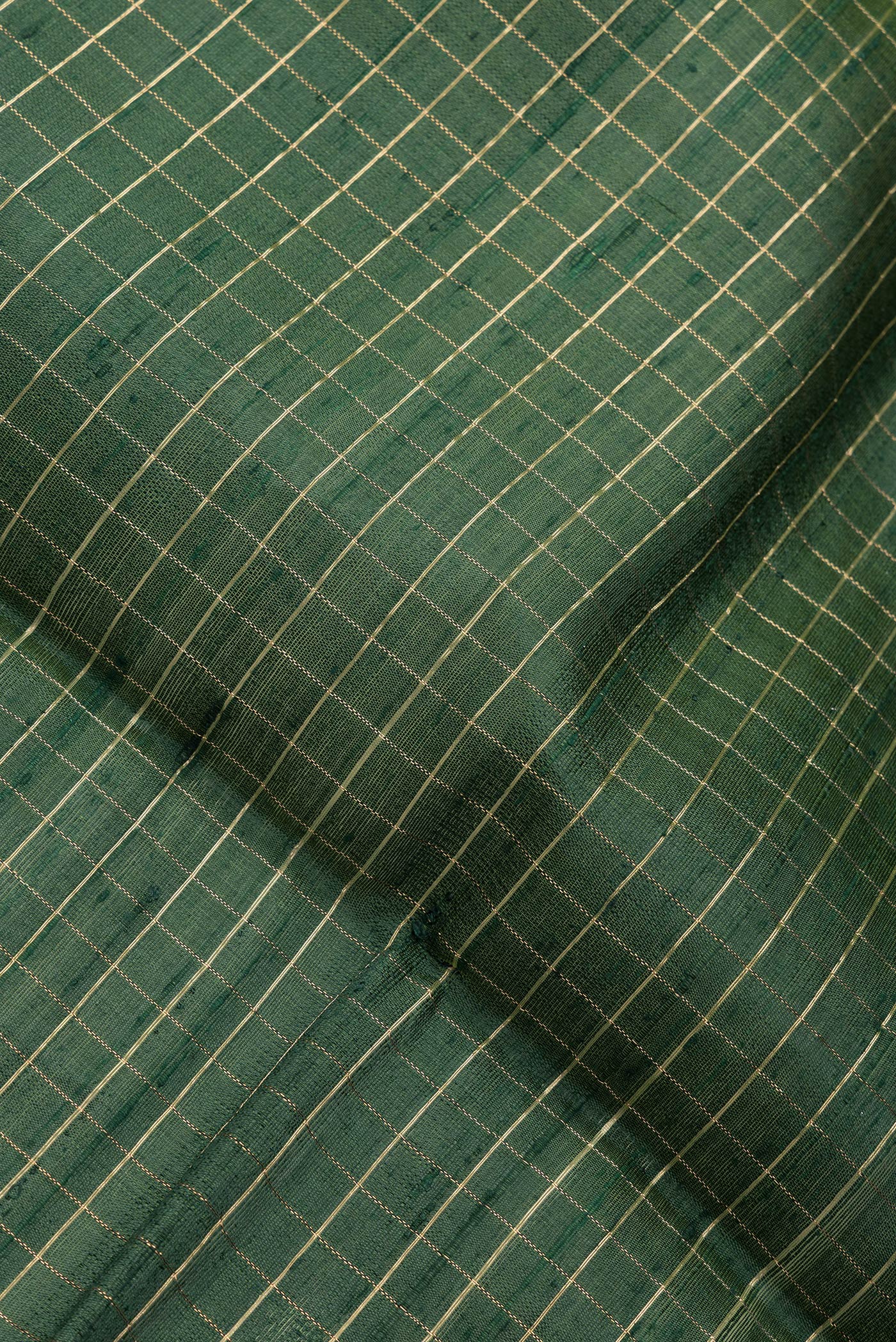 Close up of Bottle Green Dual Tone Raw Silk Saree with Checked design on the body and Zari Border.  displaying folds