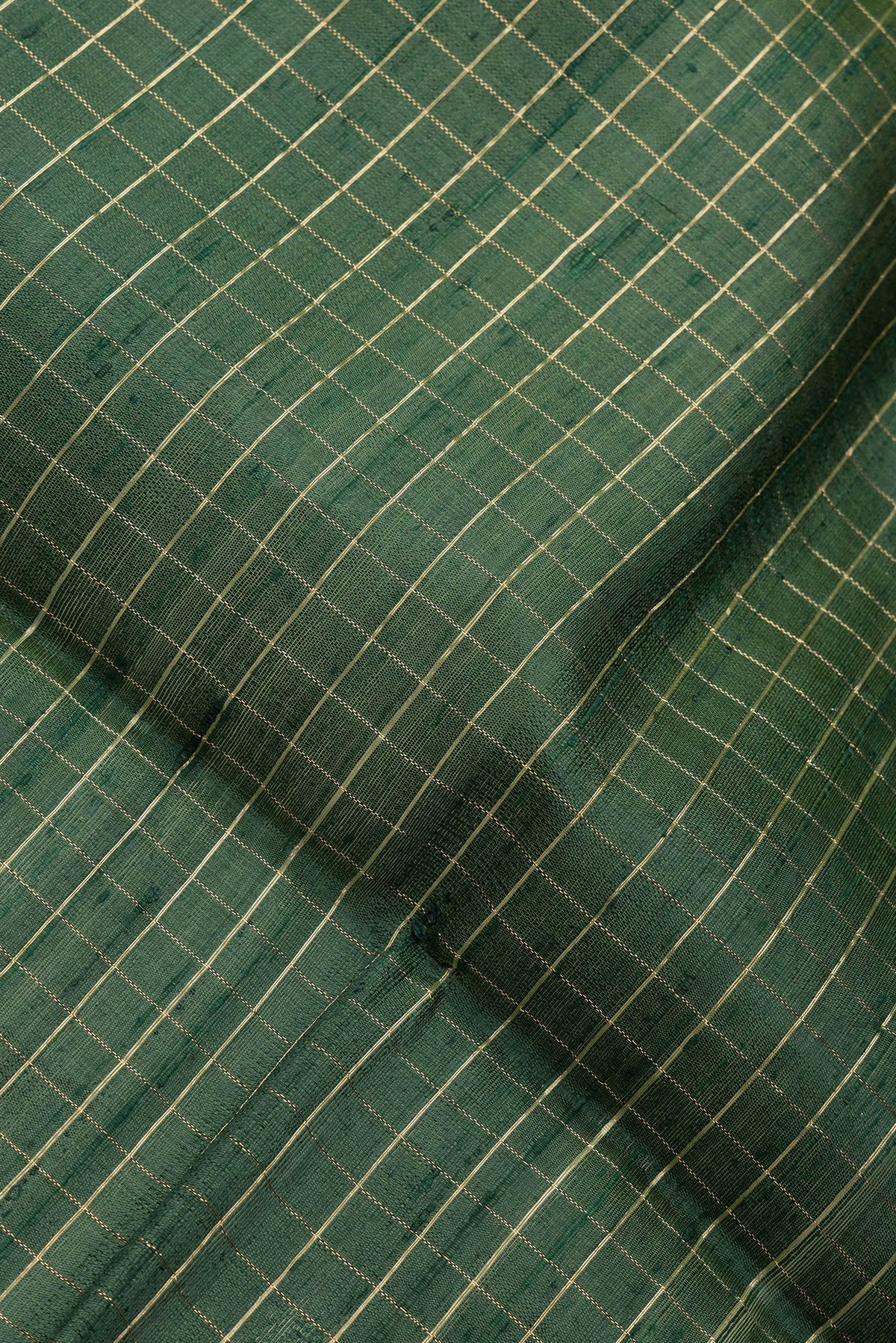 Close up of Bottle Green Dual Tone Raw Silk Saree with Checked design on the body and Zari Border.  displaying folds