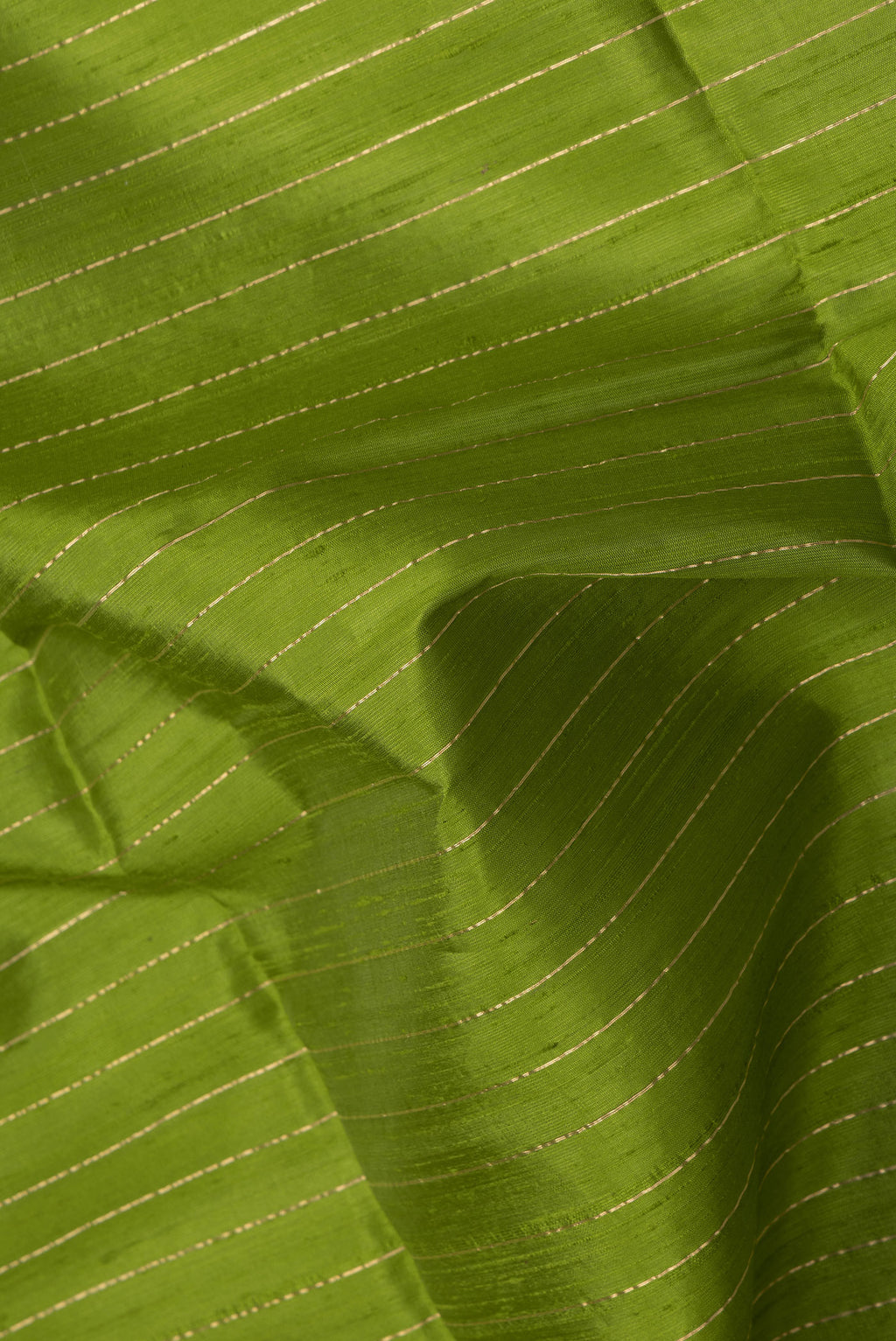 Close up of Green Dual Tone Raw Silk Saree with Stripes on the body and Temple Border.  displaying folds