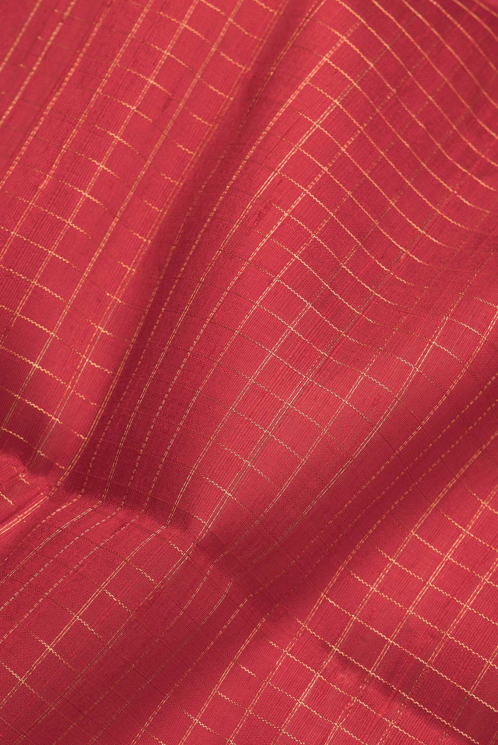 Close up of Red Dual Tone Raw Silk Saree with Checked design on the body and Zari Border.  displaying folds
