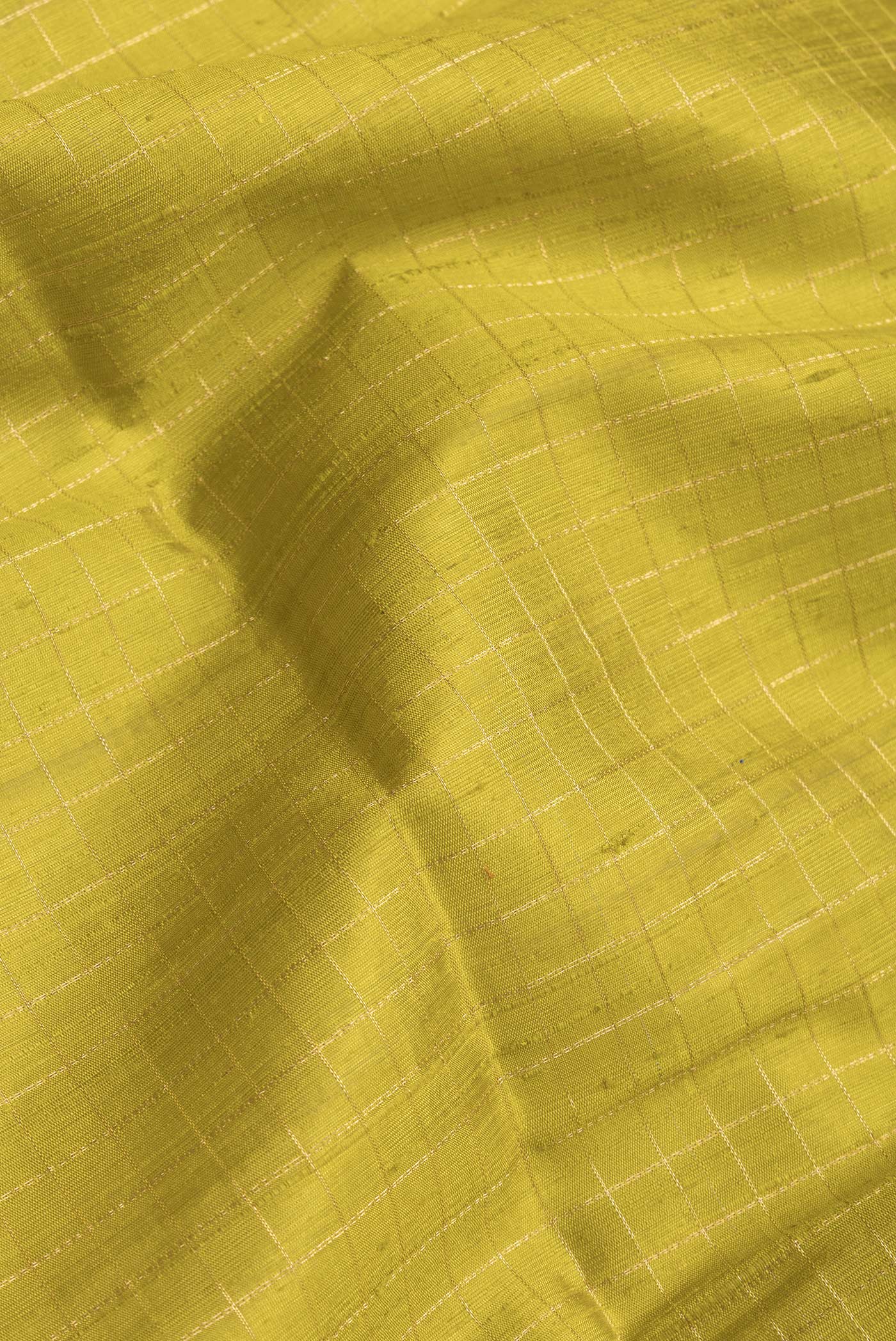 Close up of Parrot Green Dual Tone Raw Silk Saree with Checked design on the body and Zari Border.  displaying folds
