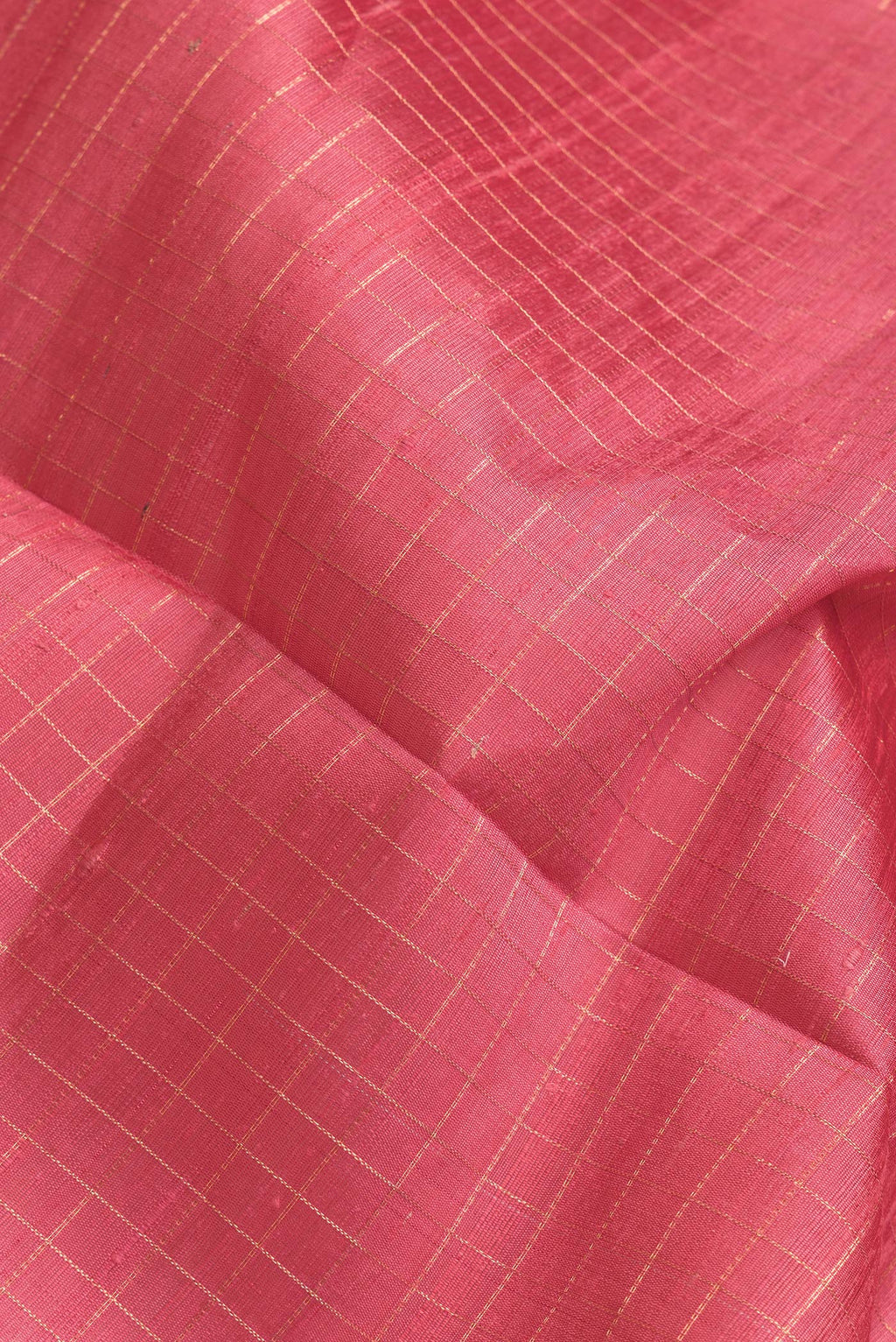 Close up of Pink Dual Tone Raw Silk Saree with Checked design on the body and Zari Border.  displaying folds