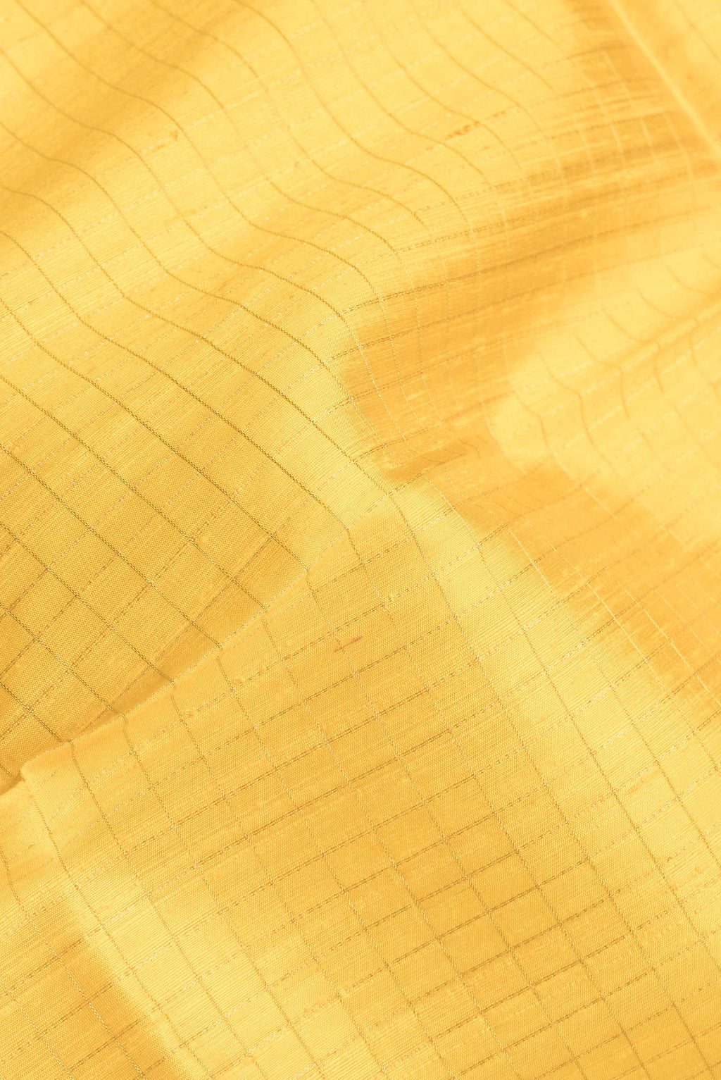Close up of Yellow Dual Tone Raw Silk Saree with Checked design on the body and Zari Border.  displaying folds
