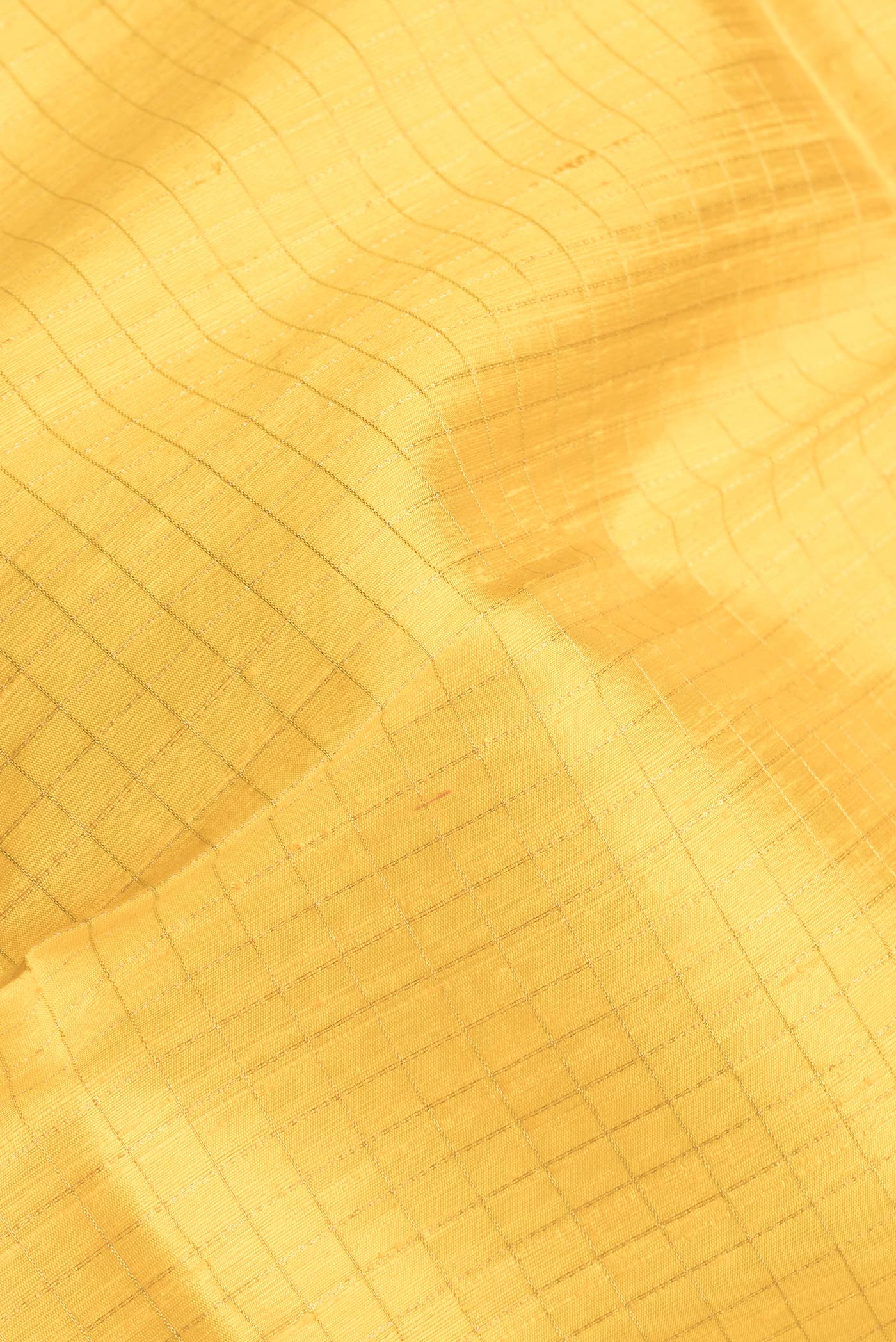 Close up of Yellow Dual Tone Raw Silk Saree with Checked design on the body and Zari Border.  displaying folds