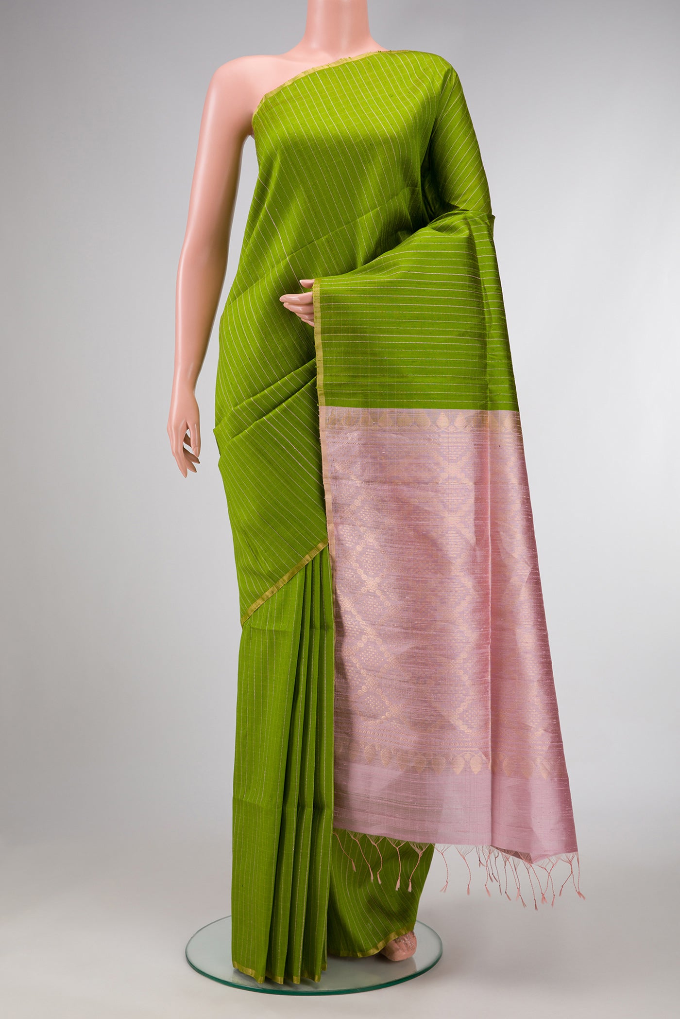 Parrot Green Dual Tone Raw Silk Saree with Zari Butta on the body and Zari Border.  displayed on a mannequin