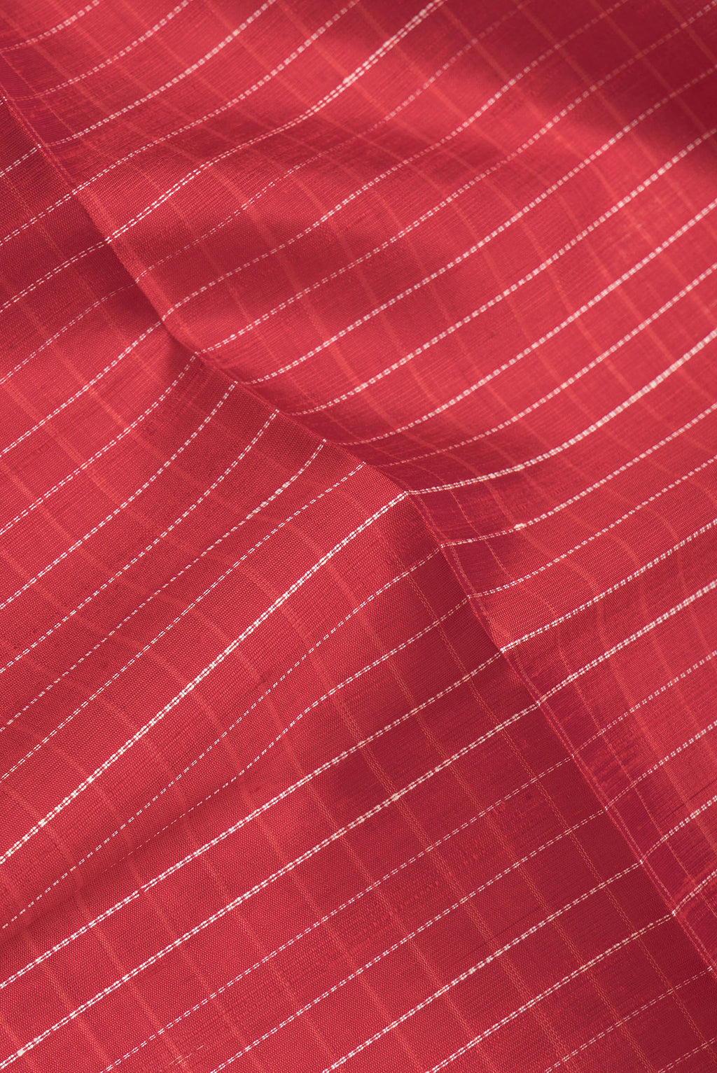 Close up of Red Dual Tone Raw Silk Saree with Checked design on the body and Zari Border.  displaying folds