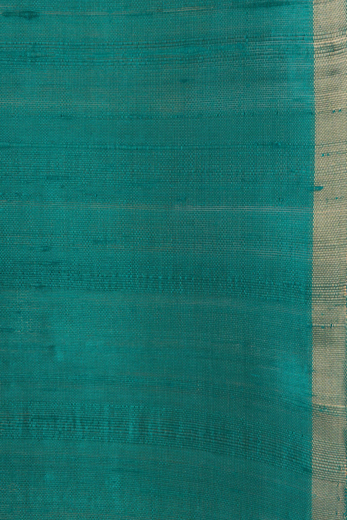 Border image of Peacock Blue Dual Tone Raw Silk Saree with Plain Body and Thin Zari Line. 