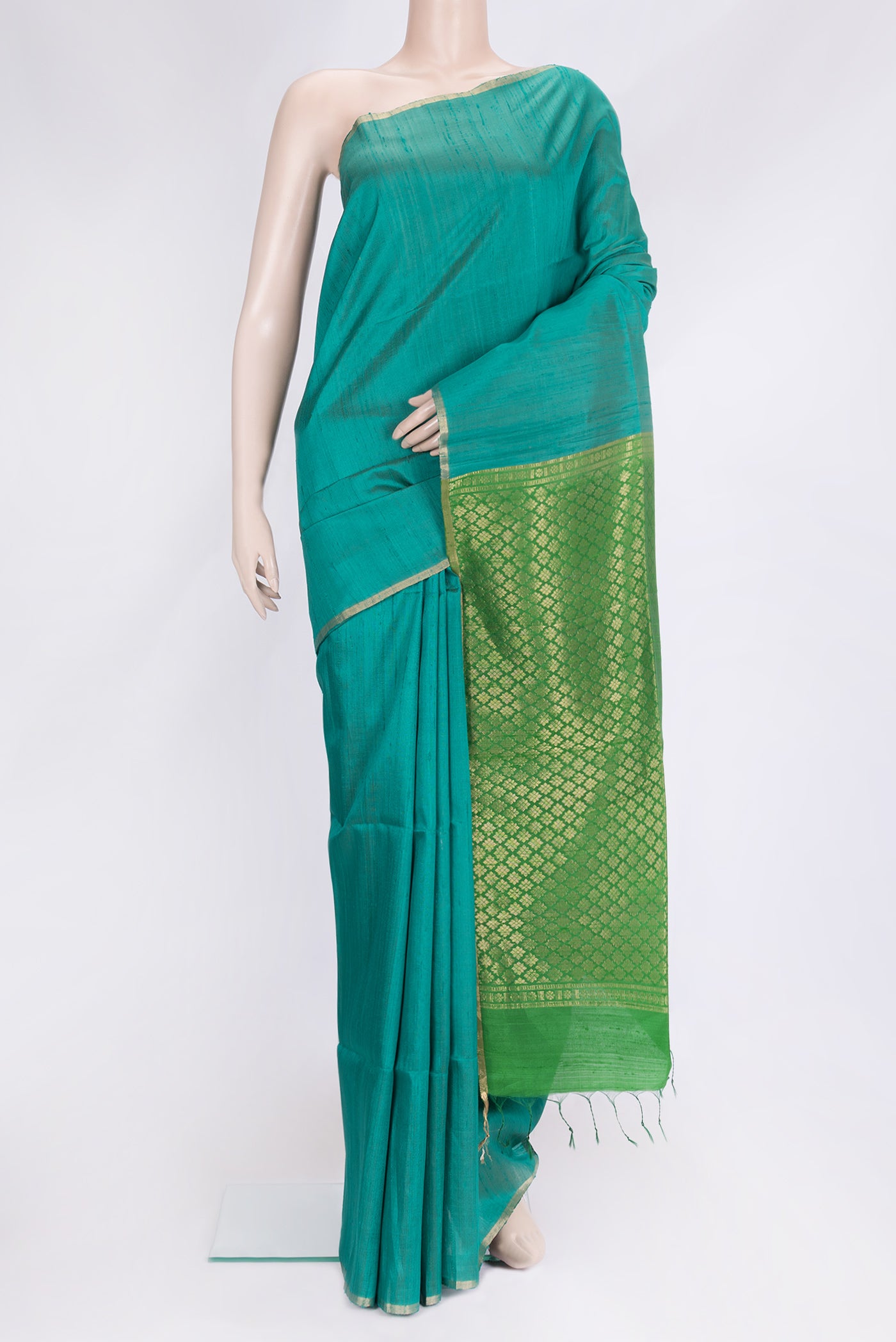 Peacock Blue Dual Tone Raw Silk Saree with Plain Body and Thin Zari Line.  displayed on a mannequin