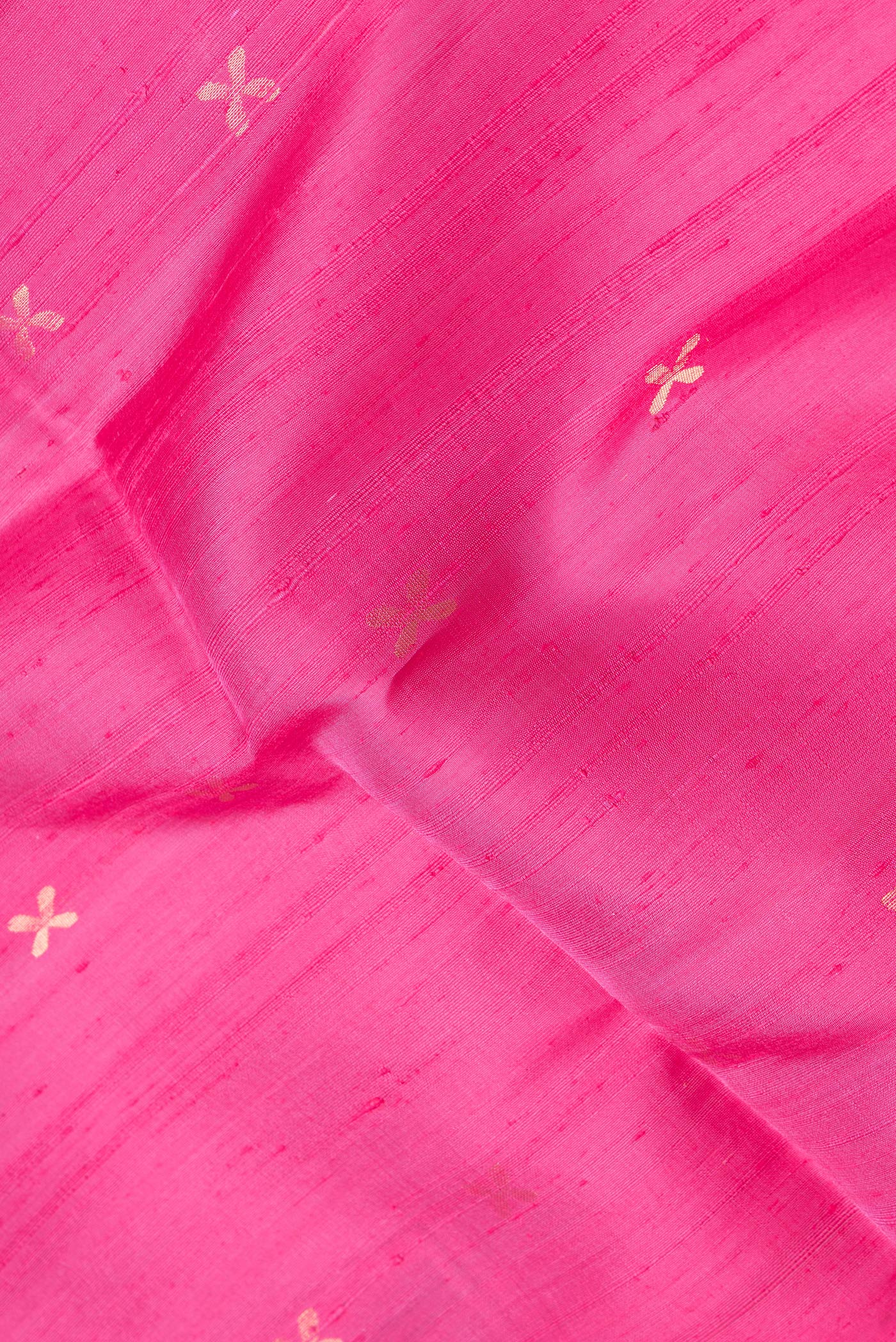 Close up of Pink Dual Tone Raw Silk Saree with Zari Butta on the body and Thin Zari Line.  displaying folds