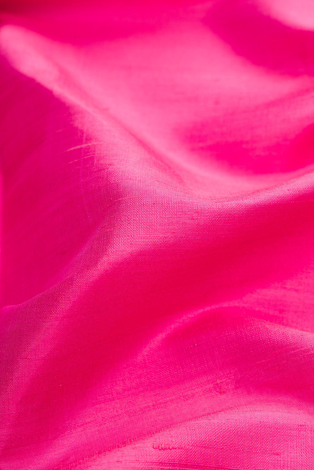 Close up of Pink Dual Tone Raw Silk Saree with Zari Butta on the body and Zari Border.  displaying folds