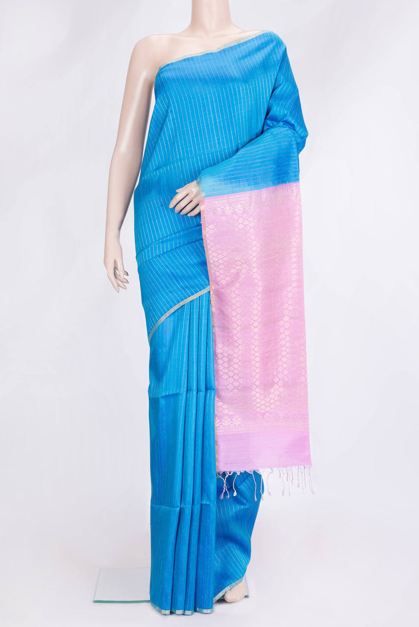 Sky Blue Dual Tone Raw Silk Saree with Stripes on the body and Thin Zari Line.  displayed on a mannequin