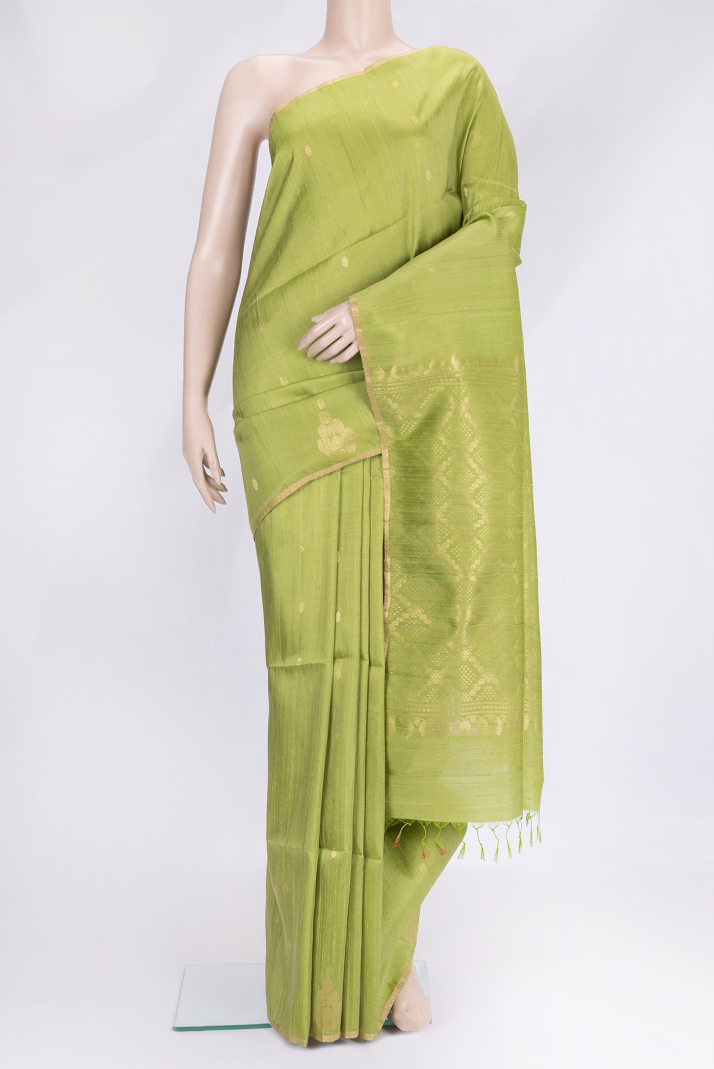 Parrot Green Dual Tone Raw Silk Saree with Zari Butta on the body and Fancy Border.  displayed on a mannequin