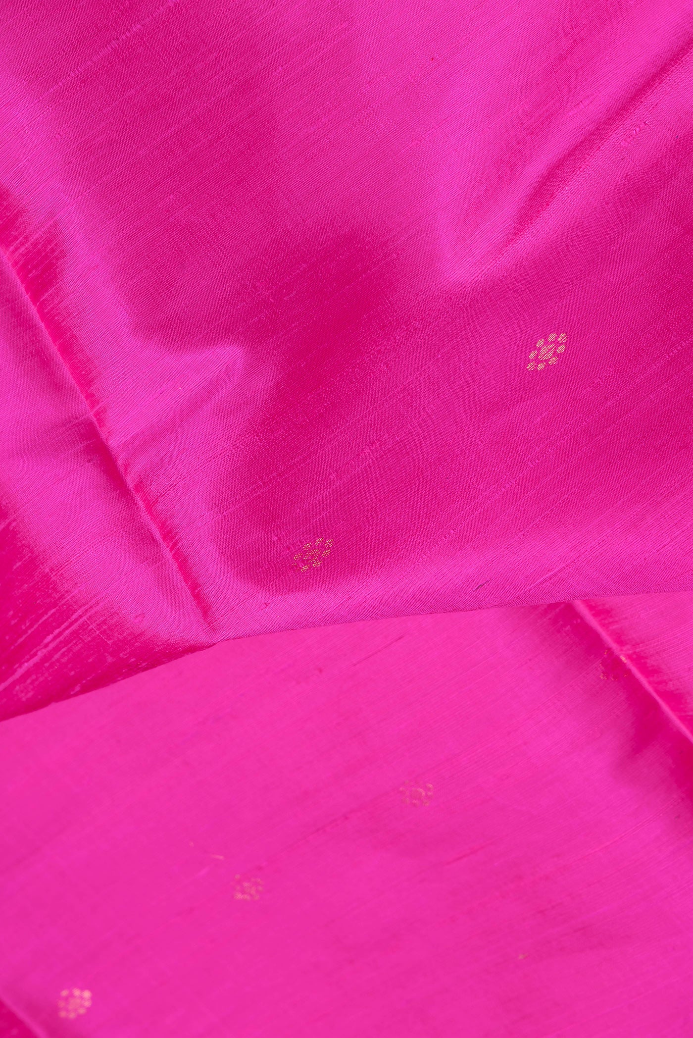 Close up of Dark Pink Dual Tone Raw Silk Saree with Zari Butta on the body and Fancy Border.  displaying folds