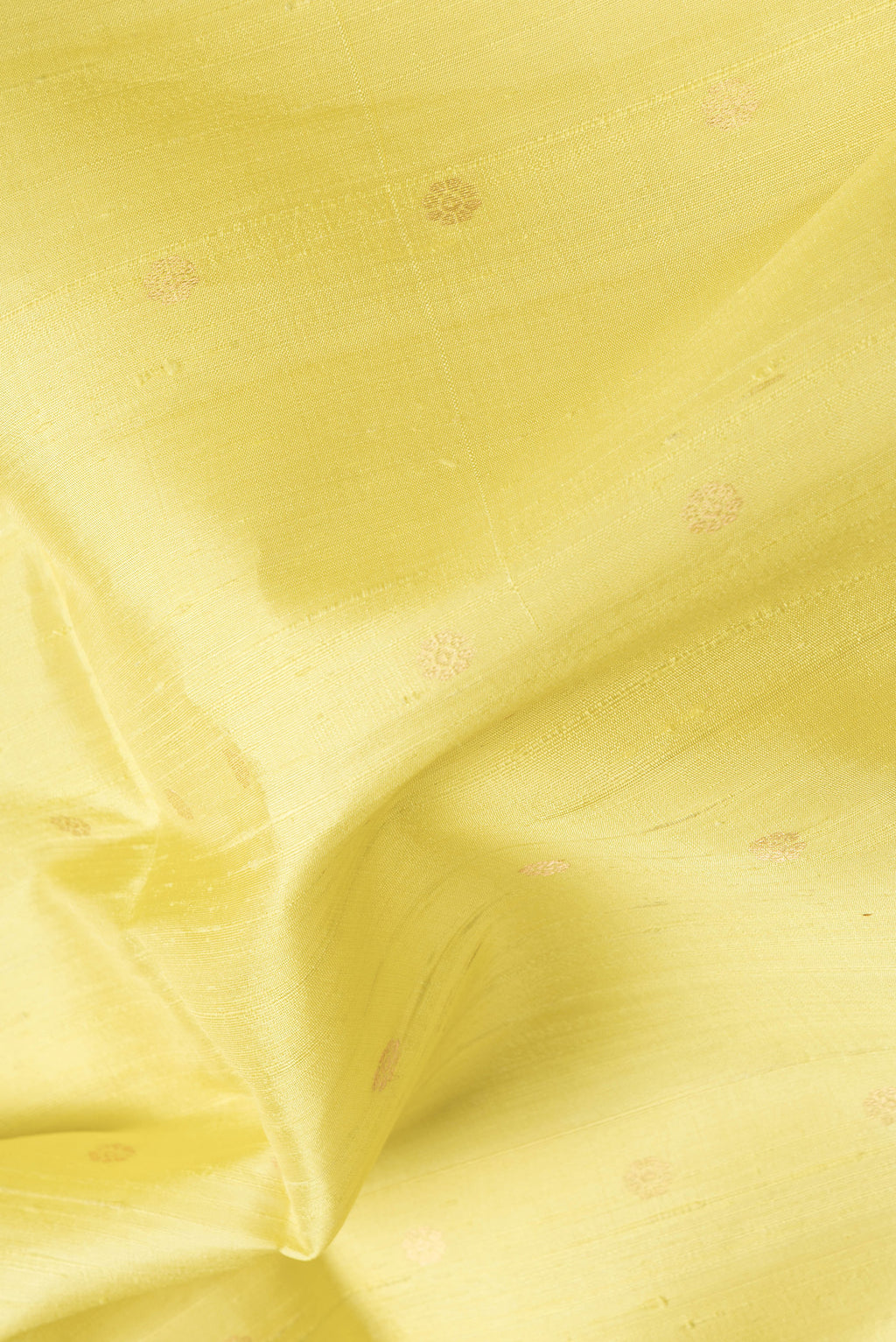 Close up of Lemon Yellow Dual Tone Raw Silk Saree with Zari Butta on the body and Zari Border.  displaying folds