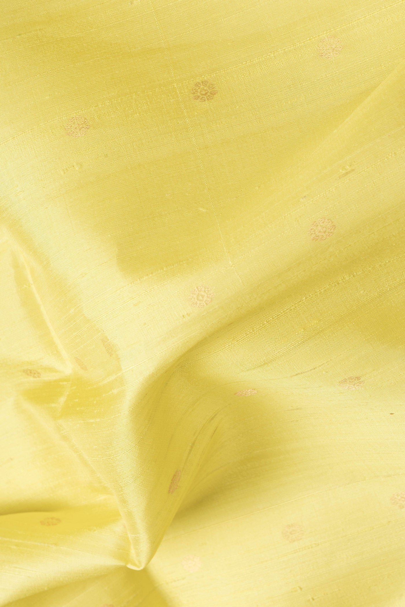 Close up of Lemon Yellow Dual Tone Raw Silk Saree with Zari Butta on the body and Zari Border.  displaying folds