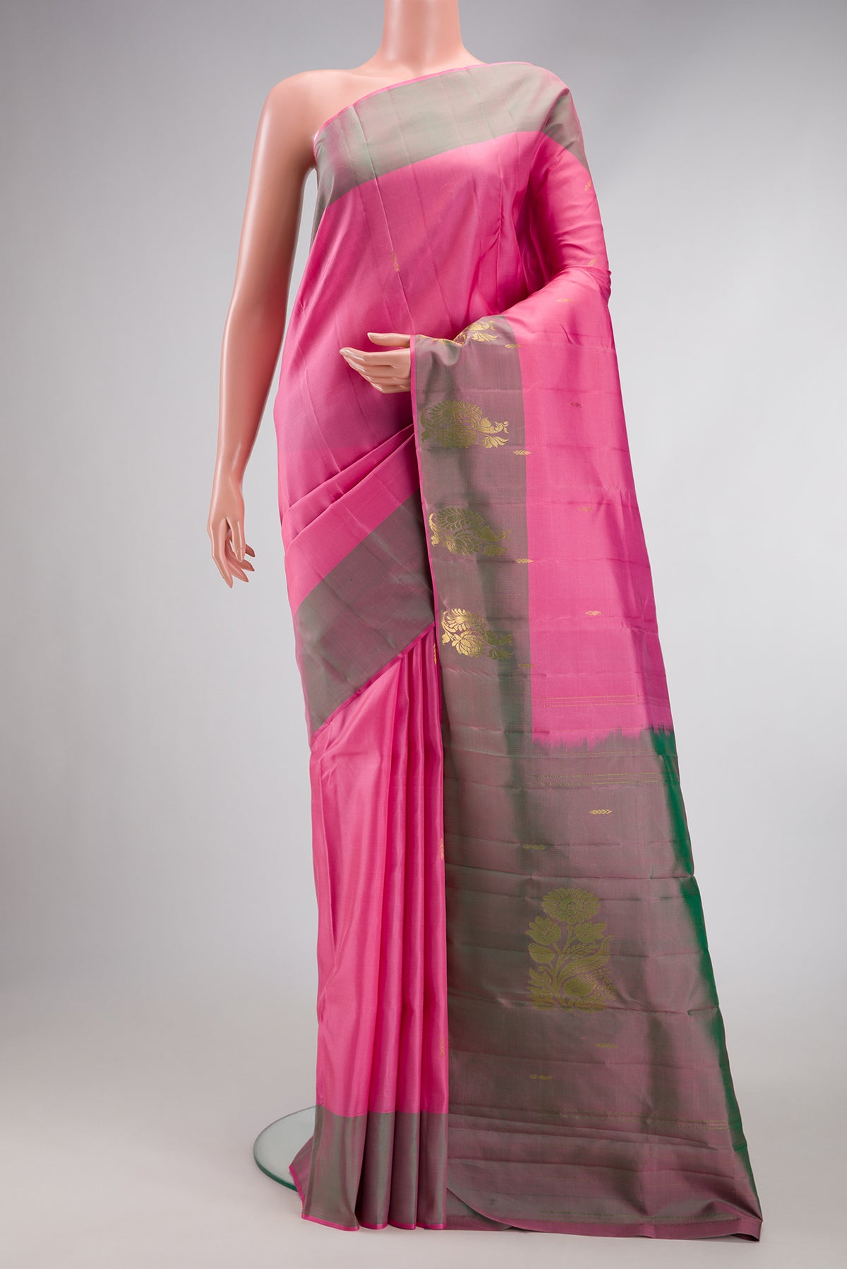 Pink Kanjivaram Silk Saree with Zari Butta on the body and Zari Border.  displayed on a mannequin