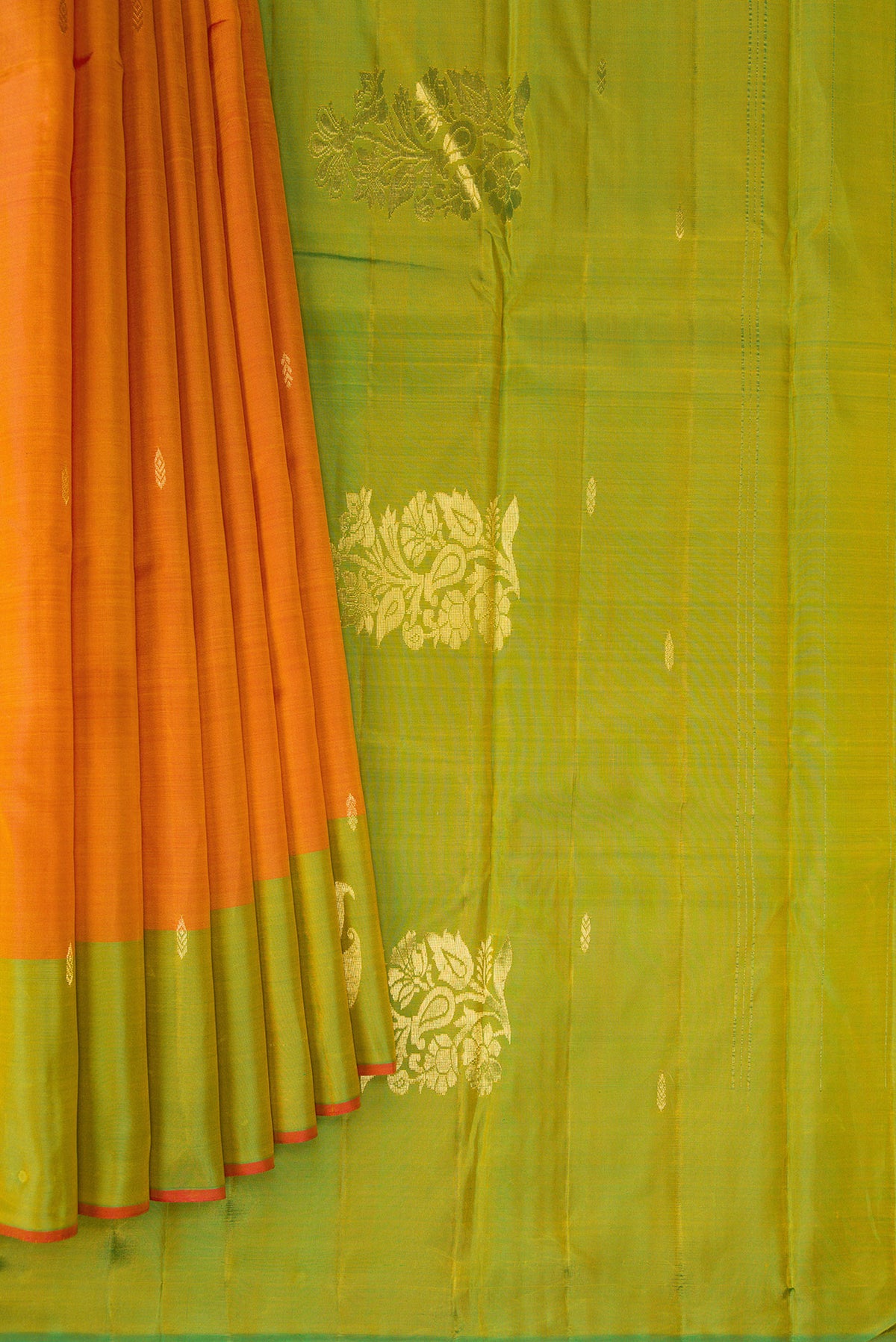 Pleats and pallu of Orange Dual Tone Soft Silk Saree with Zari Butta on the body and Zari Border. 