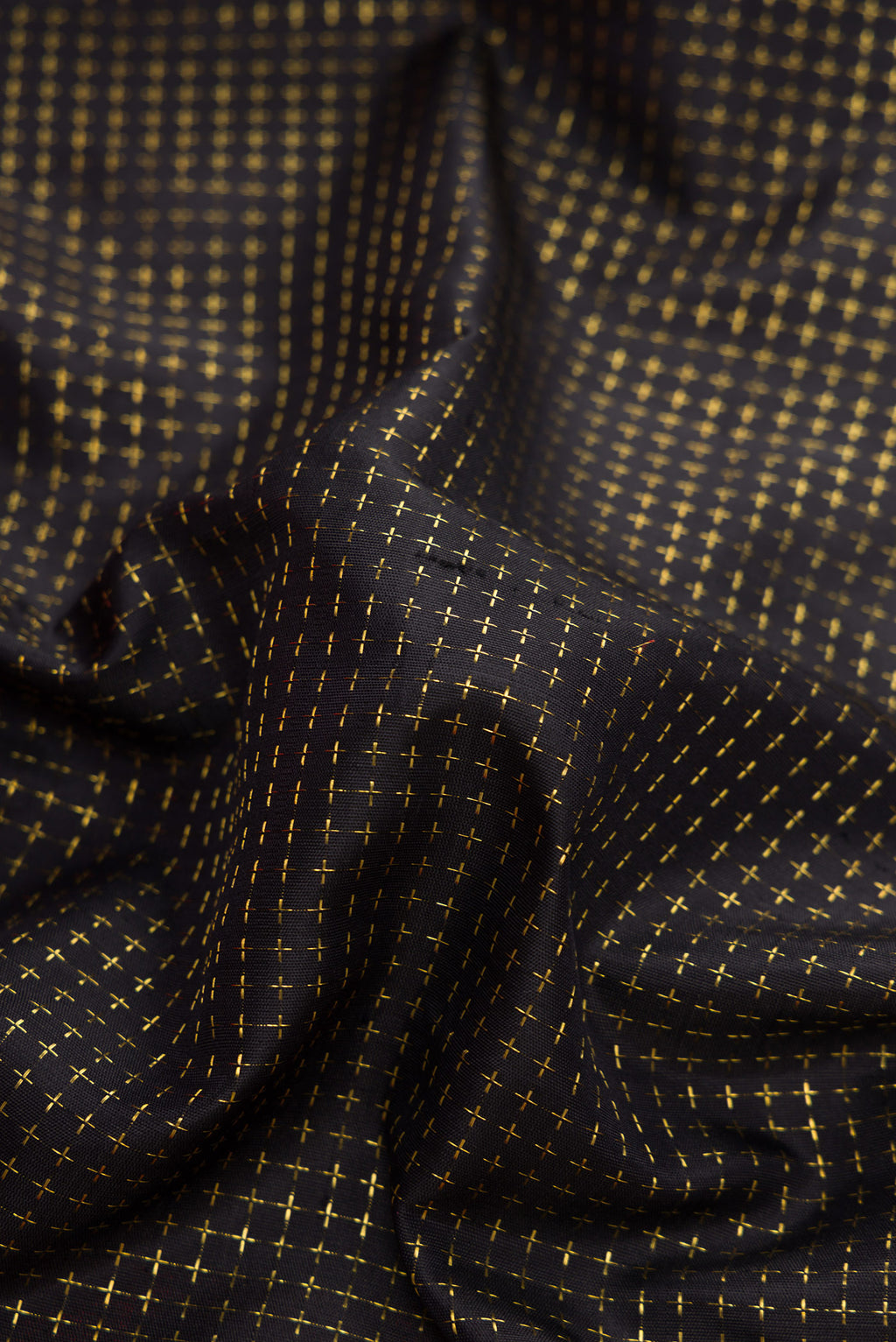 Close up of Black Dual Tone Kanjivaram Silk Saree with Checked design on the body and Zari Border.  displaying folds