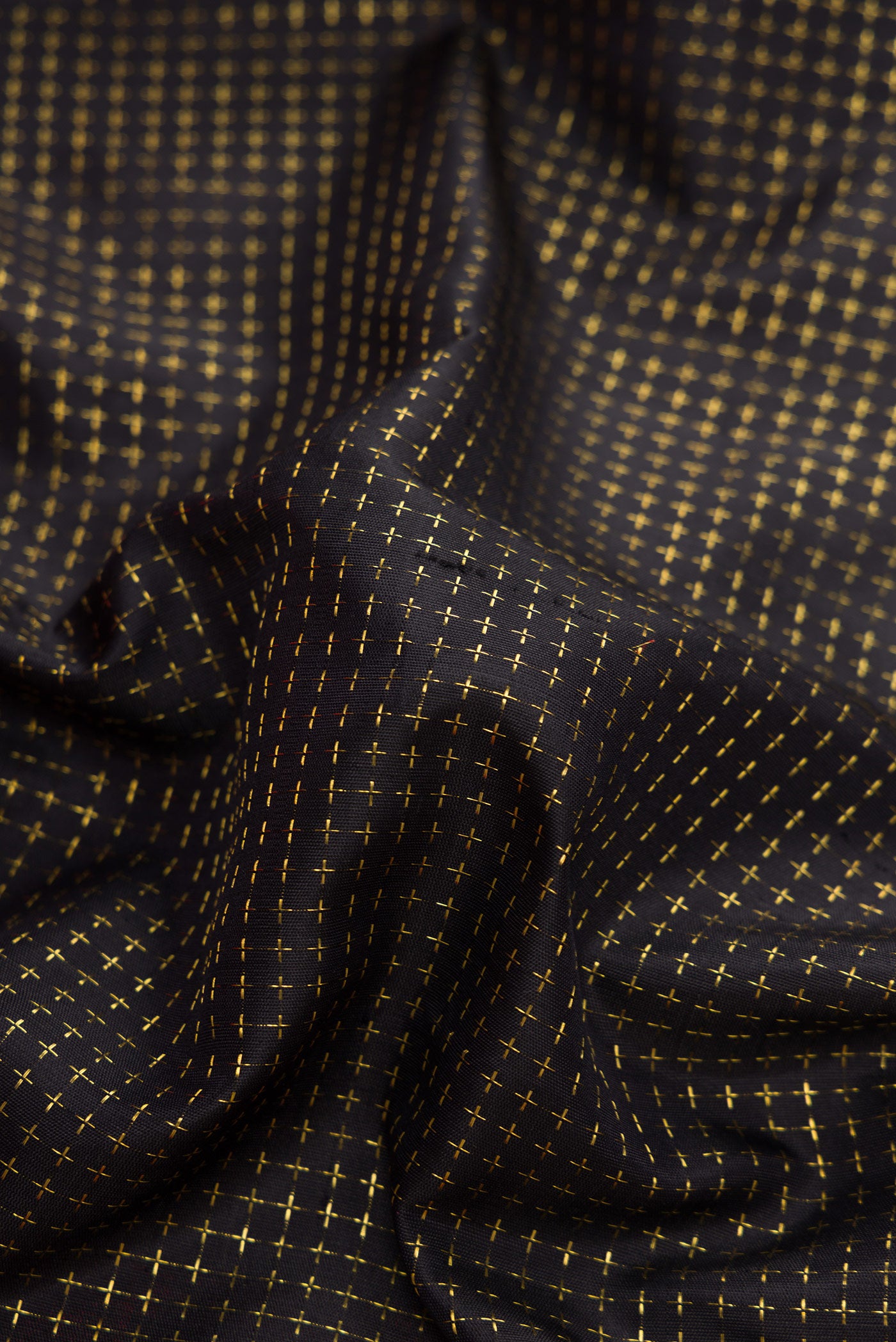 Close up of Black Dual Tone Kanjivaram Silk Saree with Checked design on the body and Zari Border.  displaying folds
