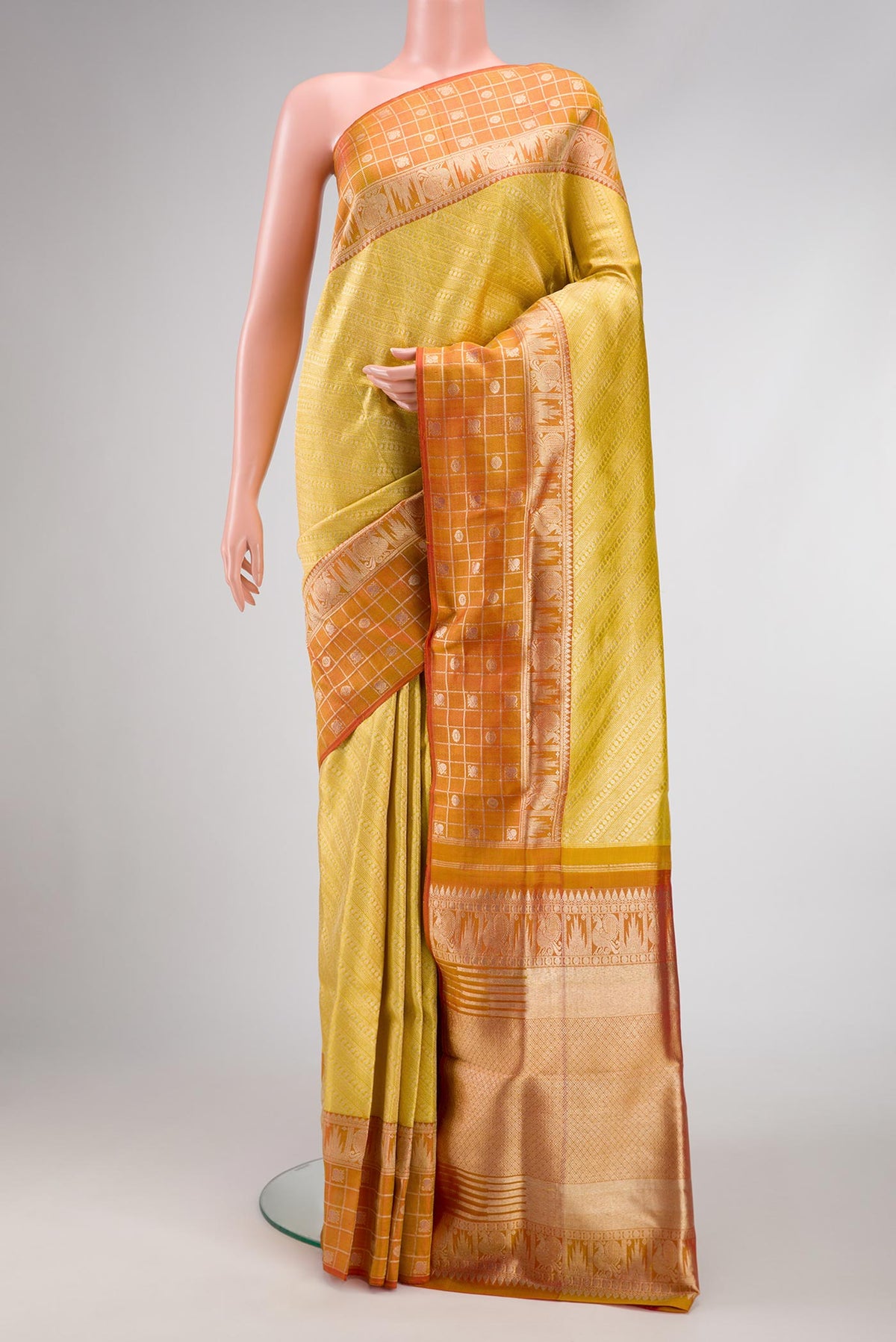 Yellow Dual Tone Kanjivaram Tissue Silk Saree with Zari Brocade on the body and Zari Border.  displayed on a mannequin