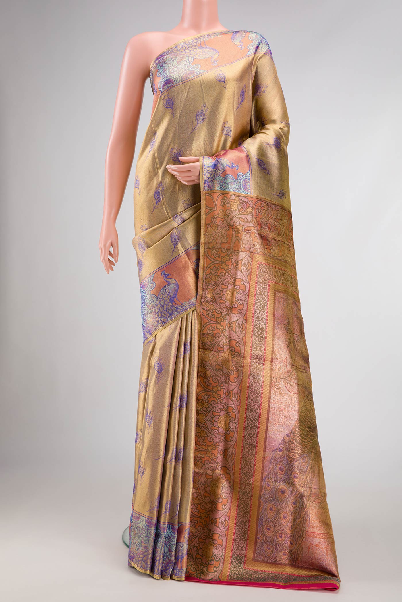 Gold Dual Tone Kanjivaram Tissue Silk Saree with Zari Brocade on the body and Fancy Border.  displayed on a mannequin
