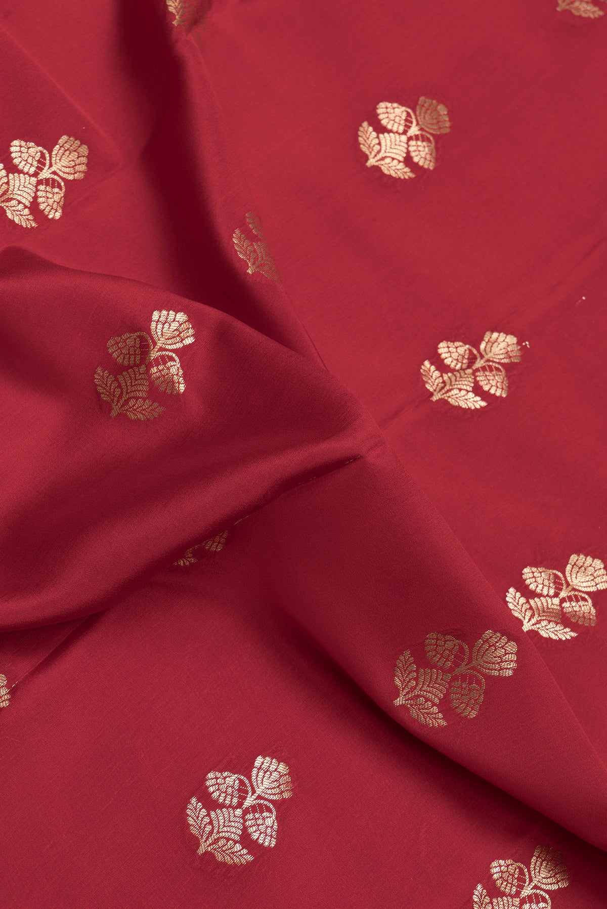 Close up of Red Dual Tone Mysore Silk Saree with Zari Butta on the body and Zari Border.  displaying folds