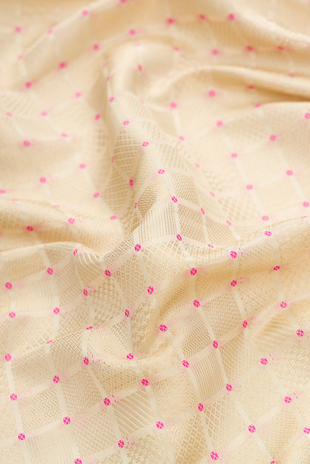 Close up of Beige Dual Tone Mysore Silk Saree with Zari Brocade on the body and Fancy Border.  displaying folds