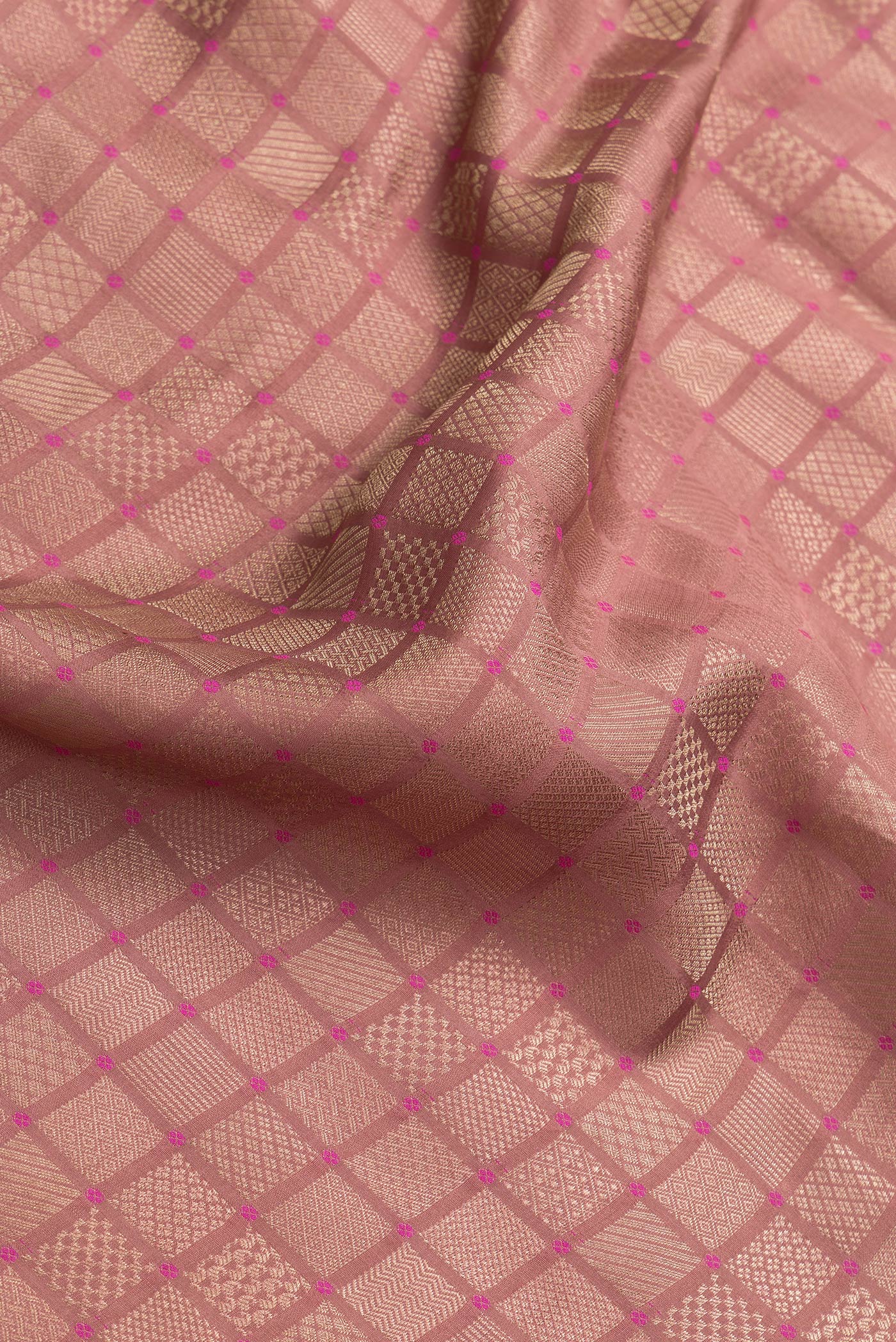 Close up of Brown Dual Tone Mysore Silk Saree with Zari Brocade on the body and Embroidery Border.  displaying folds