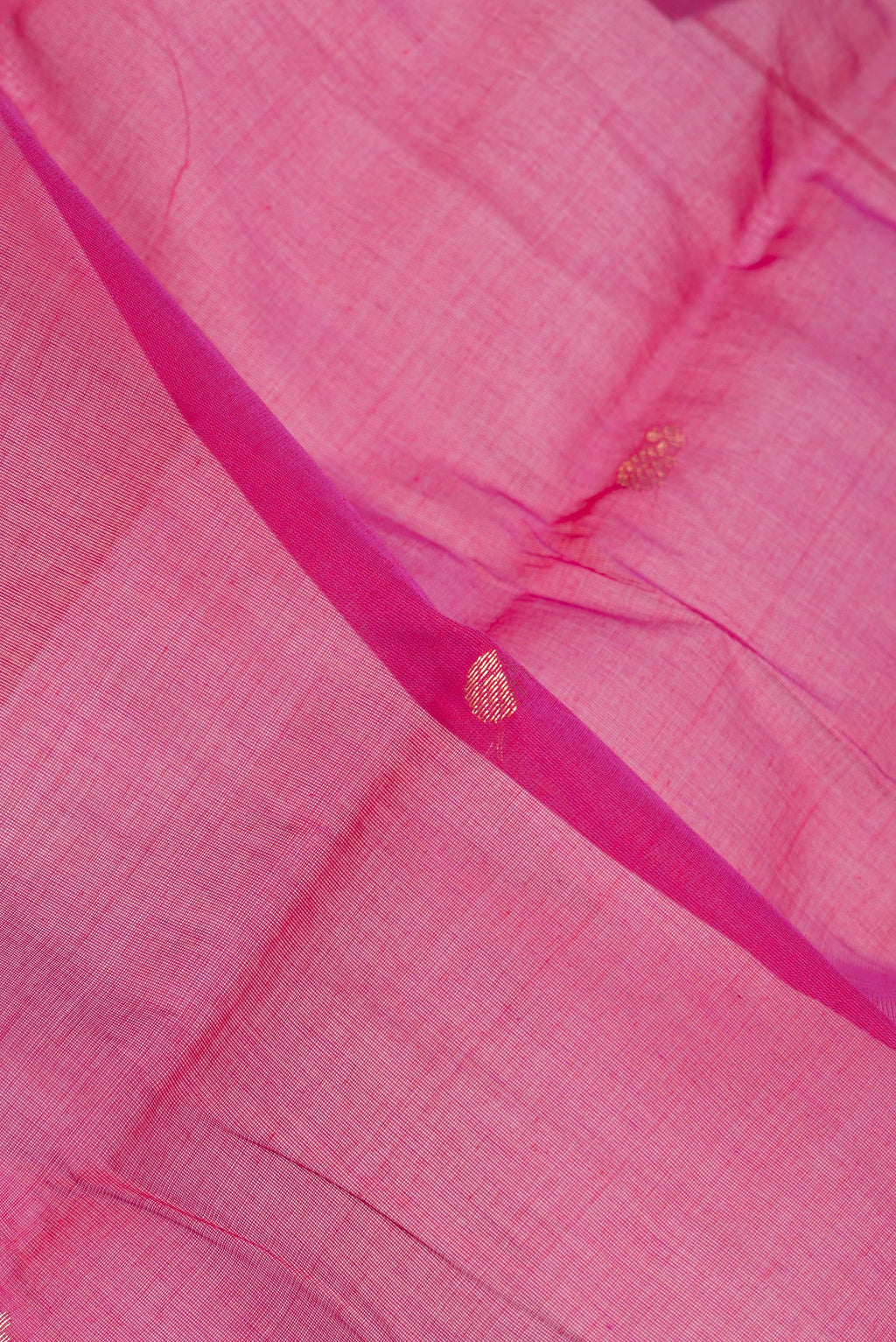 Close up of Pink Kanchi Cotton Saree with Zari Butta on the body and Zari Border.  displaying folds