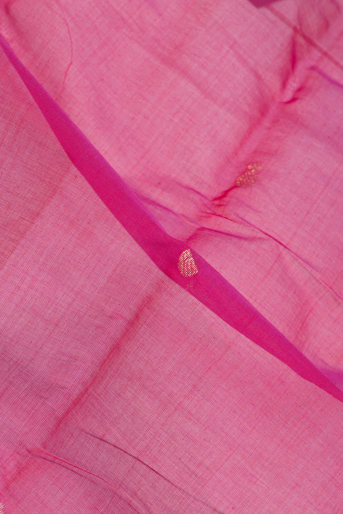 Close up of Pink Kanchi Cotton Saree with Zari Butta on the body and Zari Border.  displaying folds