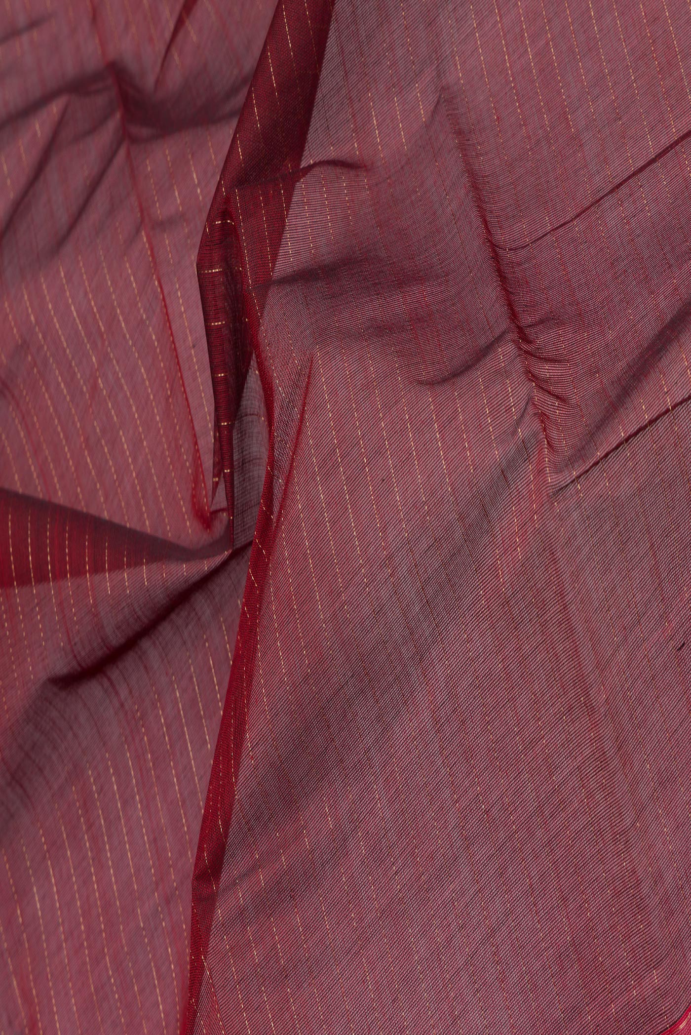 Close up of Maroon Kanchi Cotton Saree with Stripes on the body and Zari Border.  displaying folds