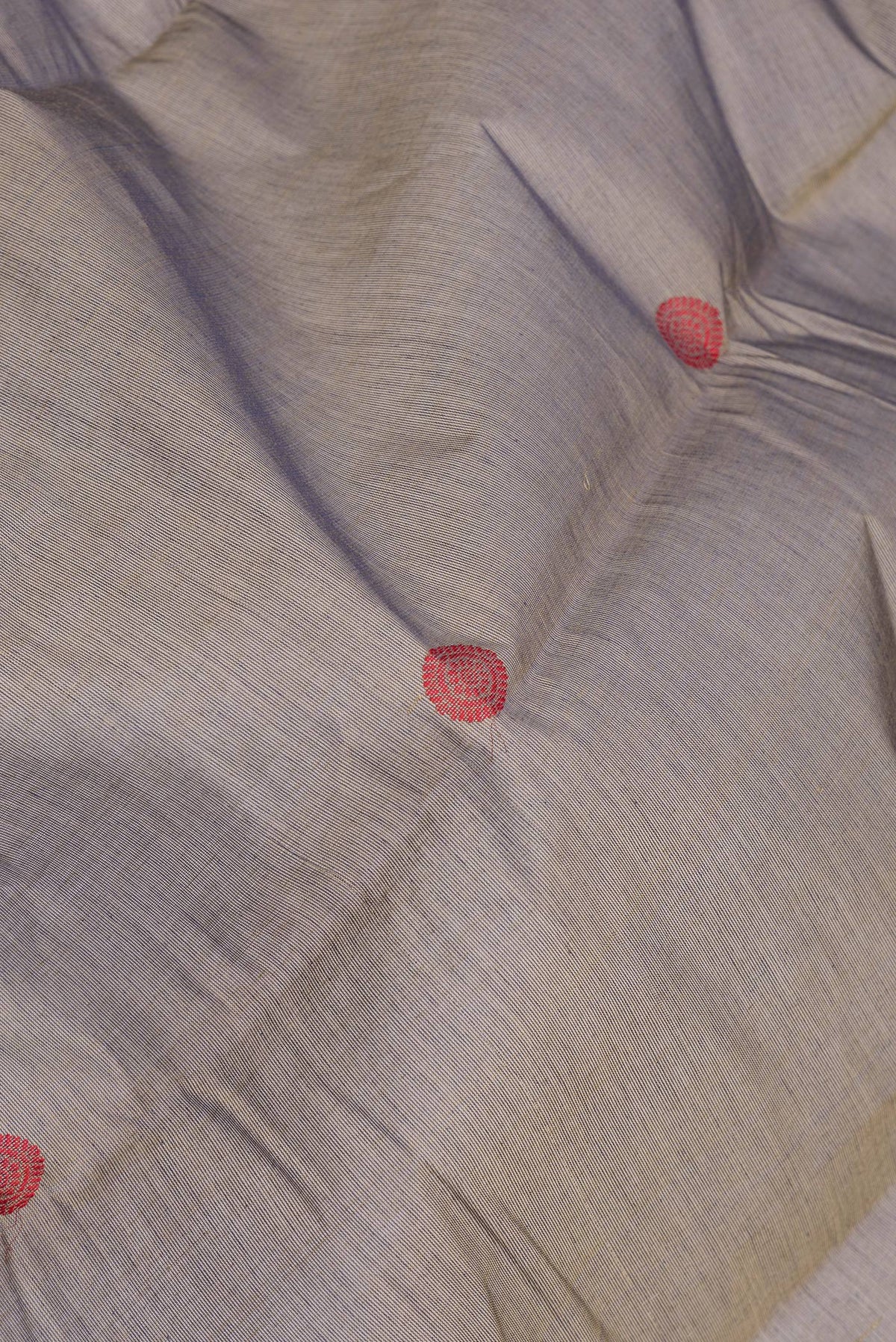 Close up of Brown Kanchi Cotton Saree with Thread Butta on the body and Zari And Thread Border.  displaying folds