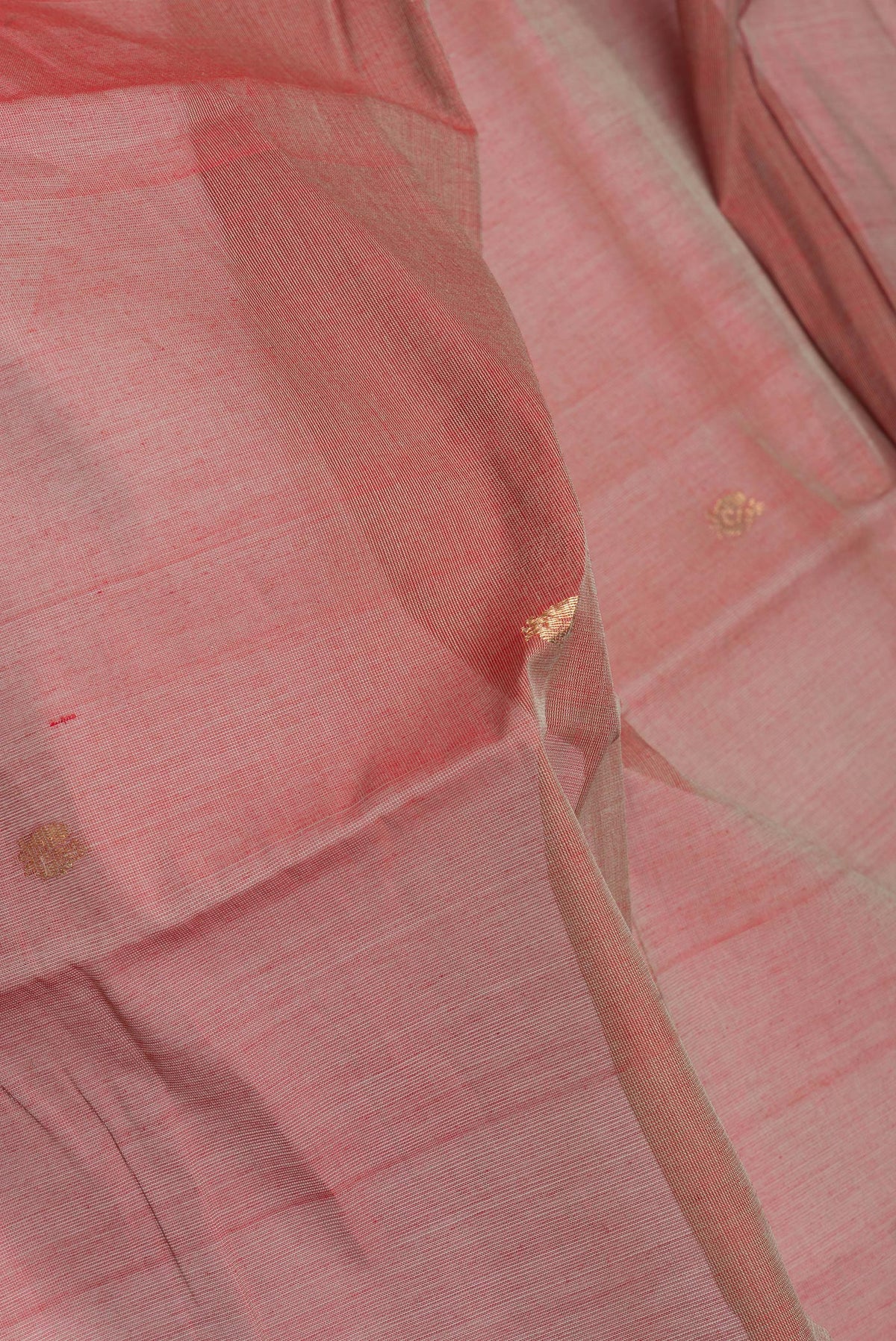 Close up of Rose Gold Kanchi Cotton Saree with Zari Butta on the body and Zari Border.  displaying folds