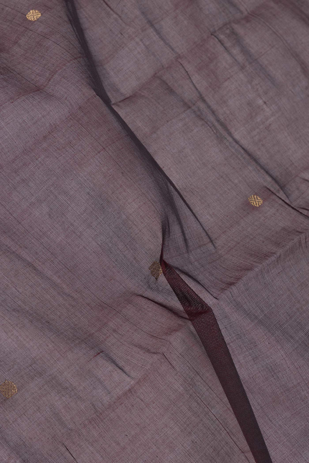 Close up of Brown Kanchi Cotton Saree with Zari Butta on the body and Zari Border.  displaying folds