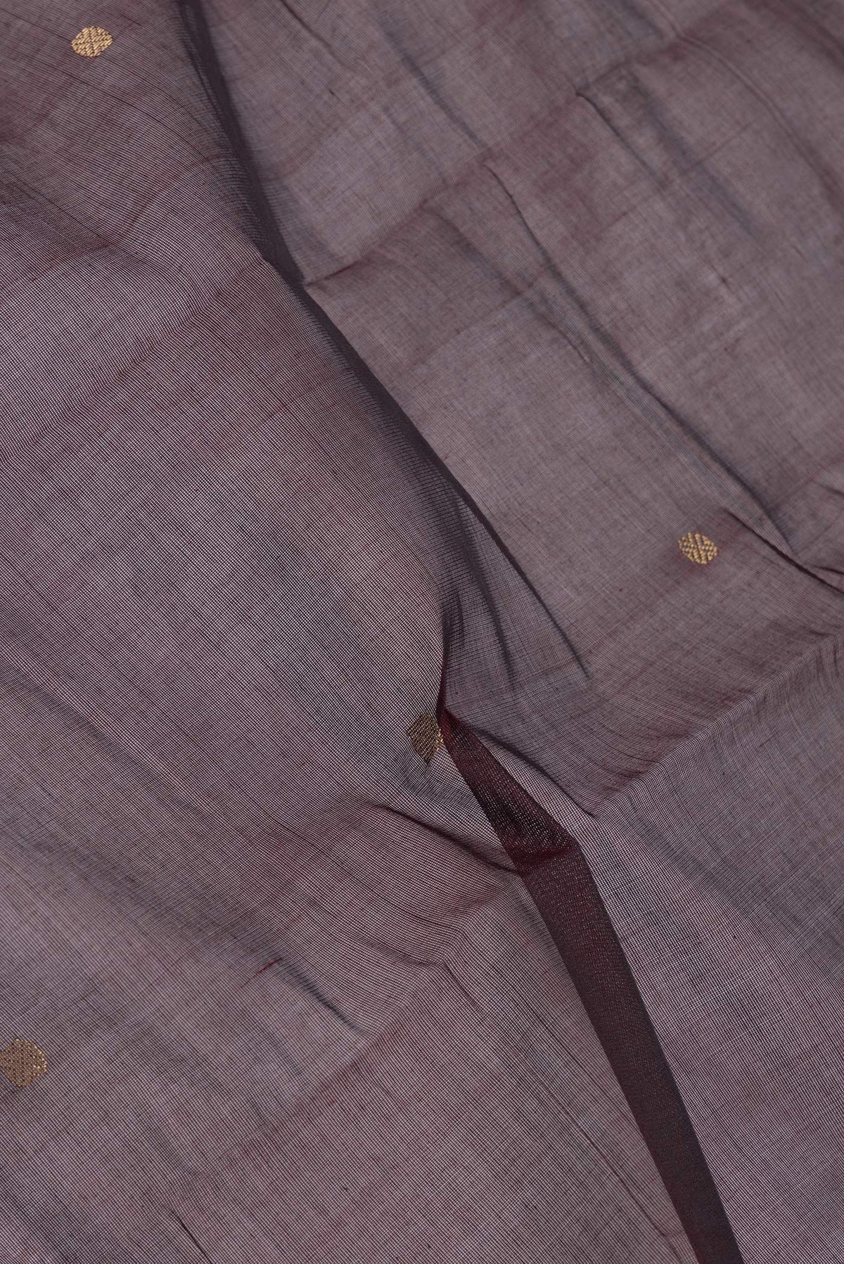Close up of Brown Kanchi Cotton Saree with Zari Butta on the body and Zari Border.  displaying folds